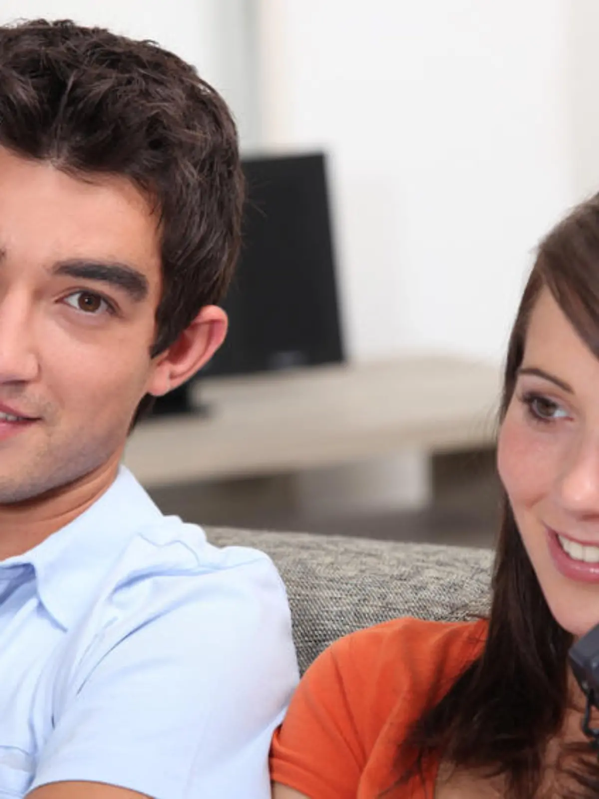 Young couple, both on the phone
