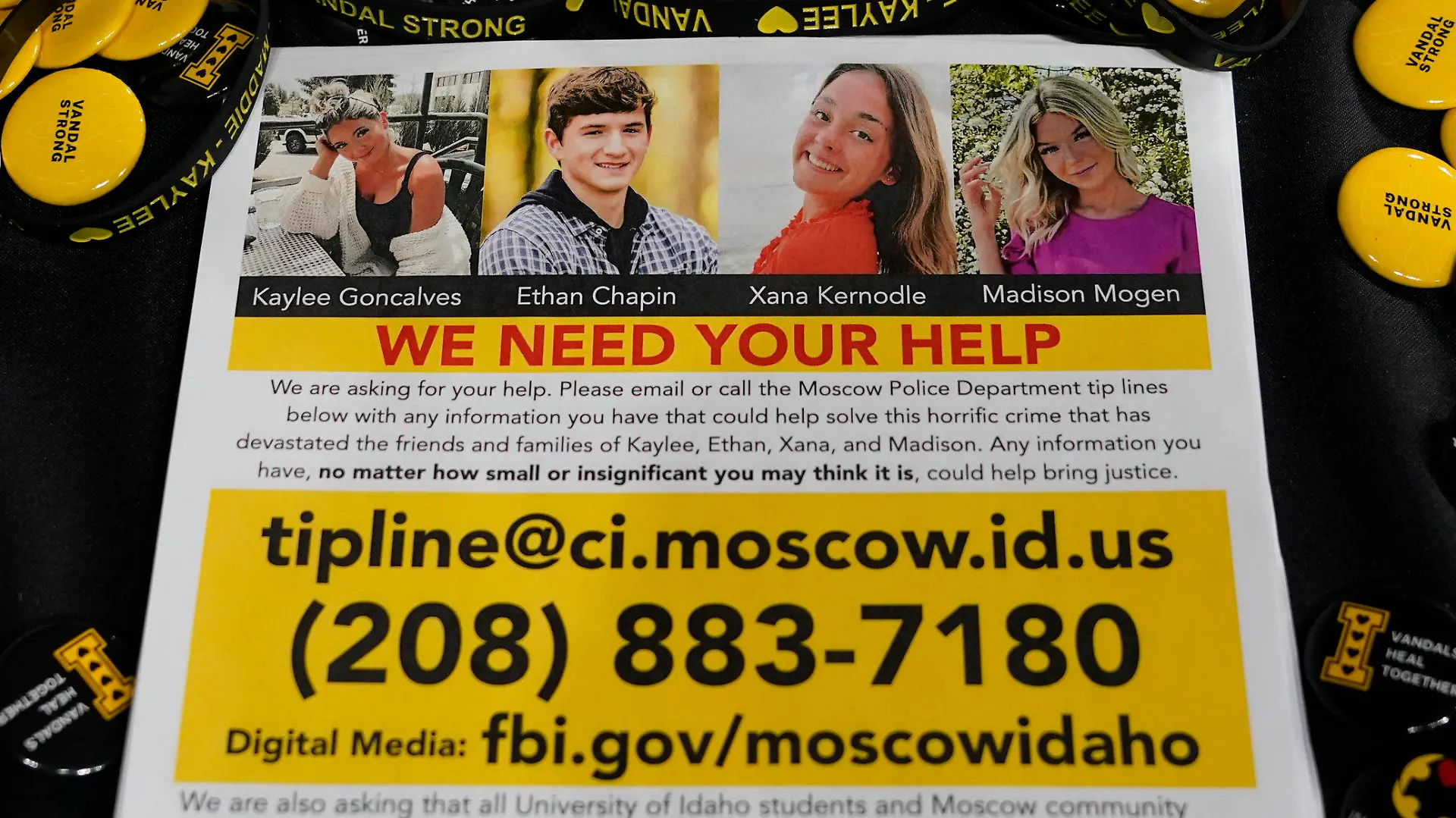 FILE - A flyer seeking information about the killings of four University of Idaho students who were found dead is displayed on a table along with buttons and bracelets on Nov. 30, 2022, during a vigil in memory of the victims in Moscow, Idaho. A suspect in the killings of four University of Idaho students was arrested in eastern Pennsylvania, a law enforcement official said Friday, Dec. 30. (AP Photo/Ted S. Warren, File)