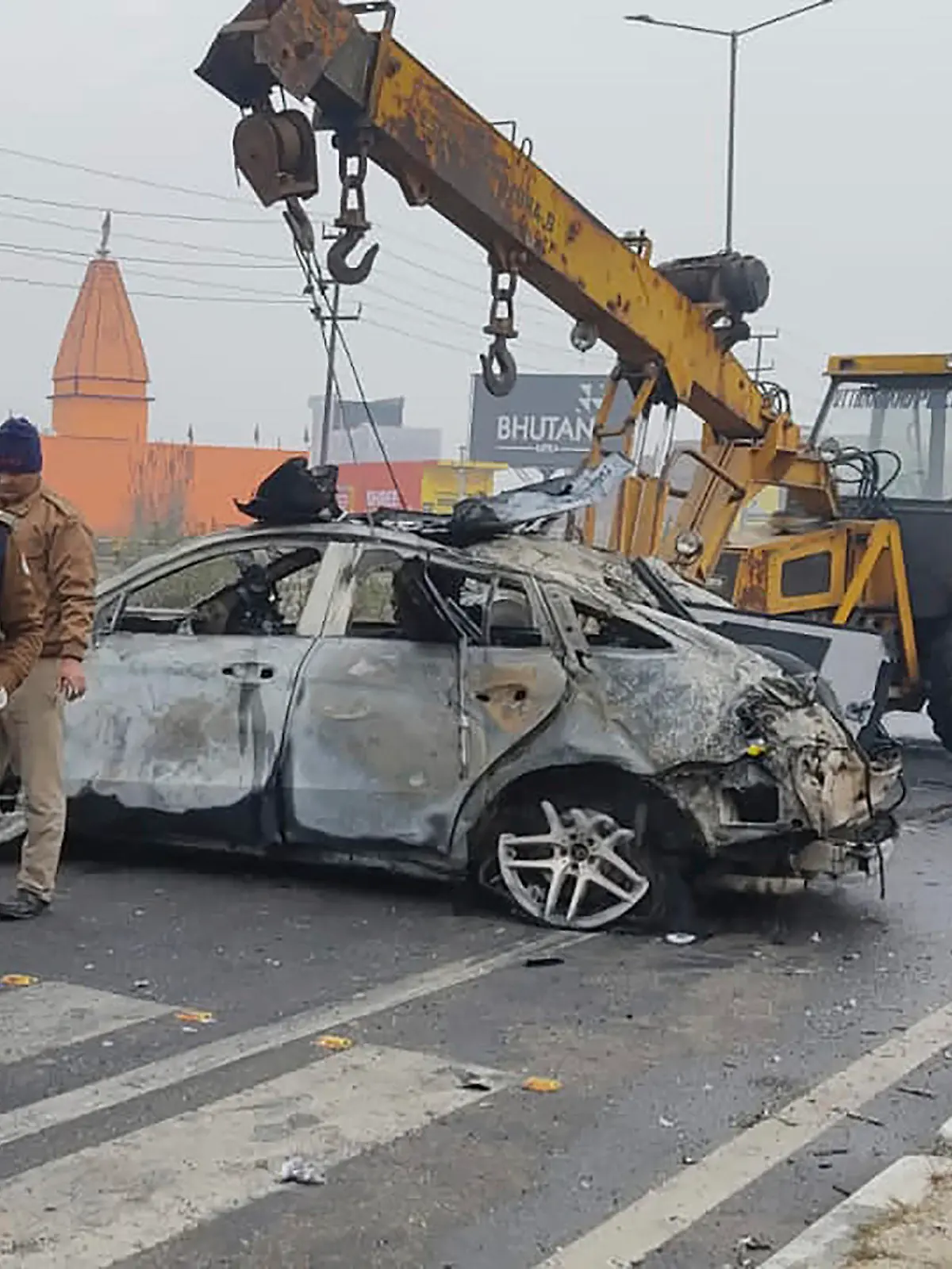 Policemen investigate the scene of a car accident near Roorkee, in the northern Indian state of Uttarakhand, Friday, Dec. 30, 2022. Indian cricketer Rishabh Pant, 25, was driving the car that overturned and caught fire after hitting a road divider, Ravi Bijaria, a state government spokesman said. Pant, who was alone at the time of the accident, was hospitalized on Friday with non life-threatening injuries. (AP Photo)