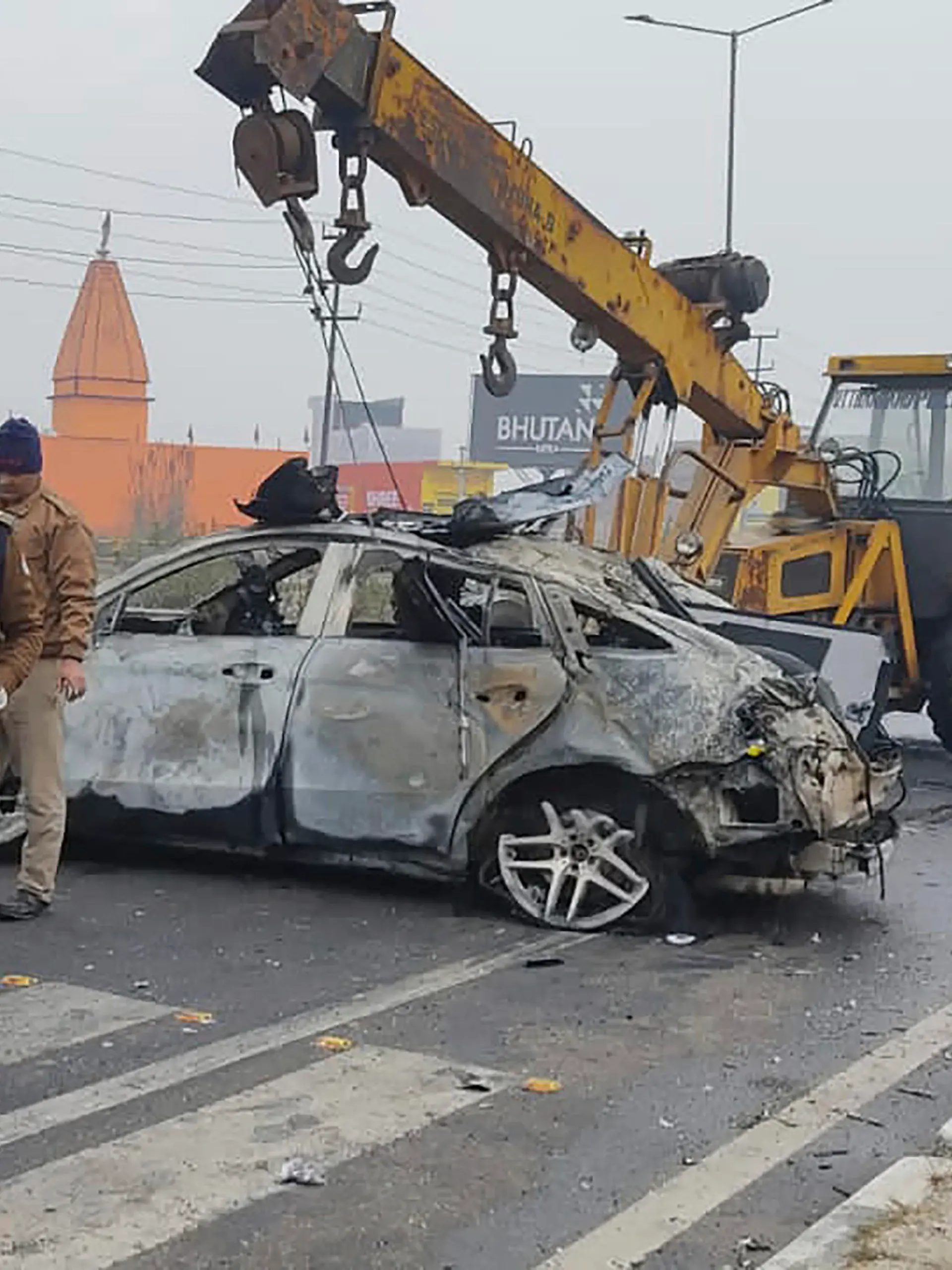 Policemen investigate the scene of a car accident near Roorkee, in the northern Indian state of Uttarakhand, Friday, Dec. 30, 2022. Indian cricketer Rishabh Pant, 25, was driving the car that overturned and caught fire after hitting a road divider, Ravi Bijaria, a state government spokesman said. Pant, who was alone at the time of the accident, was hospitalized on Friday with non life-threatening injuries. (AP Photo)