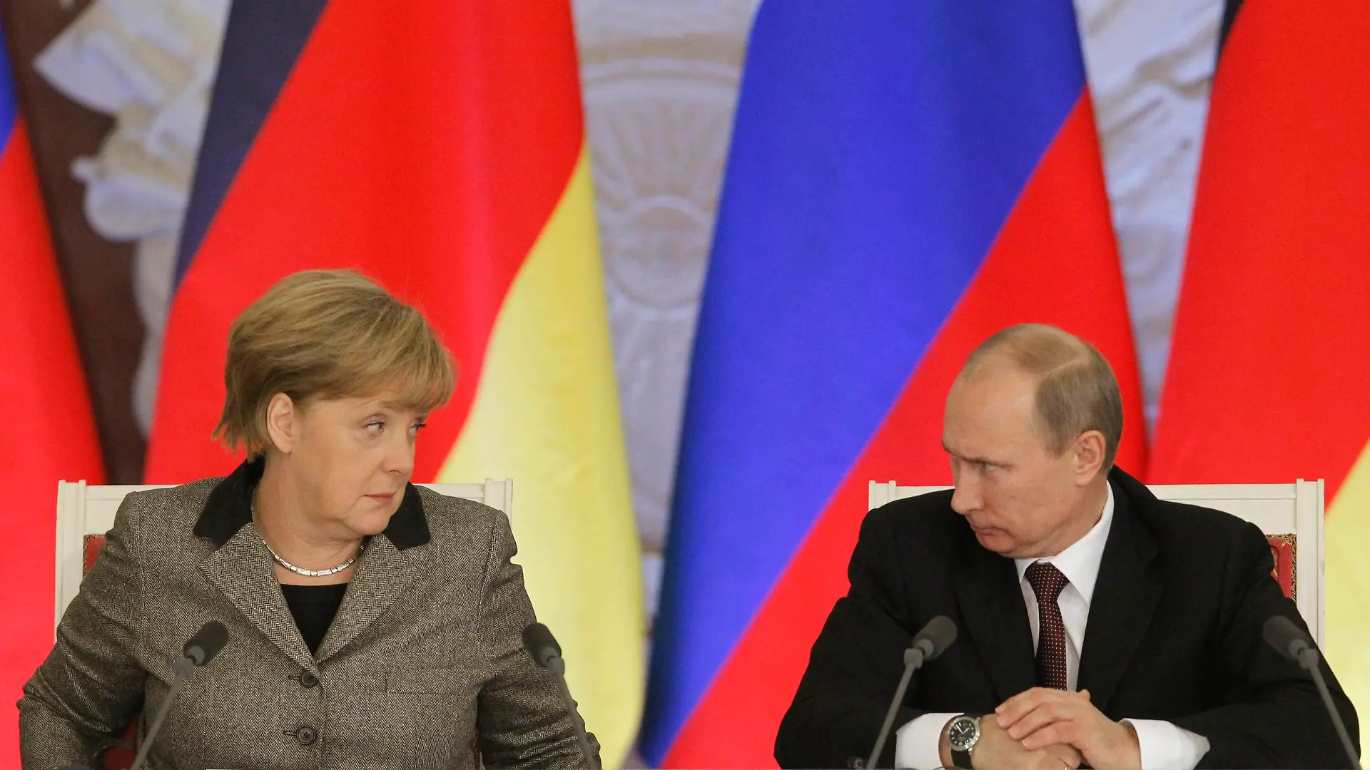 File photo of Russian President Vladimir Putin (R) and German Chancellor Angela Merkel answering journalists' questions during a joint news conference in Moscow's Kremlin November 16, 2012. On a Sunday in early March, a day after Vladimir Putin won parliamentary backing for an invasion of Ukraine, Angela Merkel called him to demand an explanation. The German leader was shaken by what she heard, sources within her party say. TO GO WITH GERMANY-RUSSIA/CRISIS REUTERS/Maxim Shemetov/Files (RUSSIA - Tags: POLITICS)