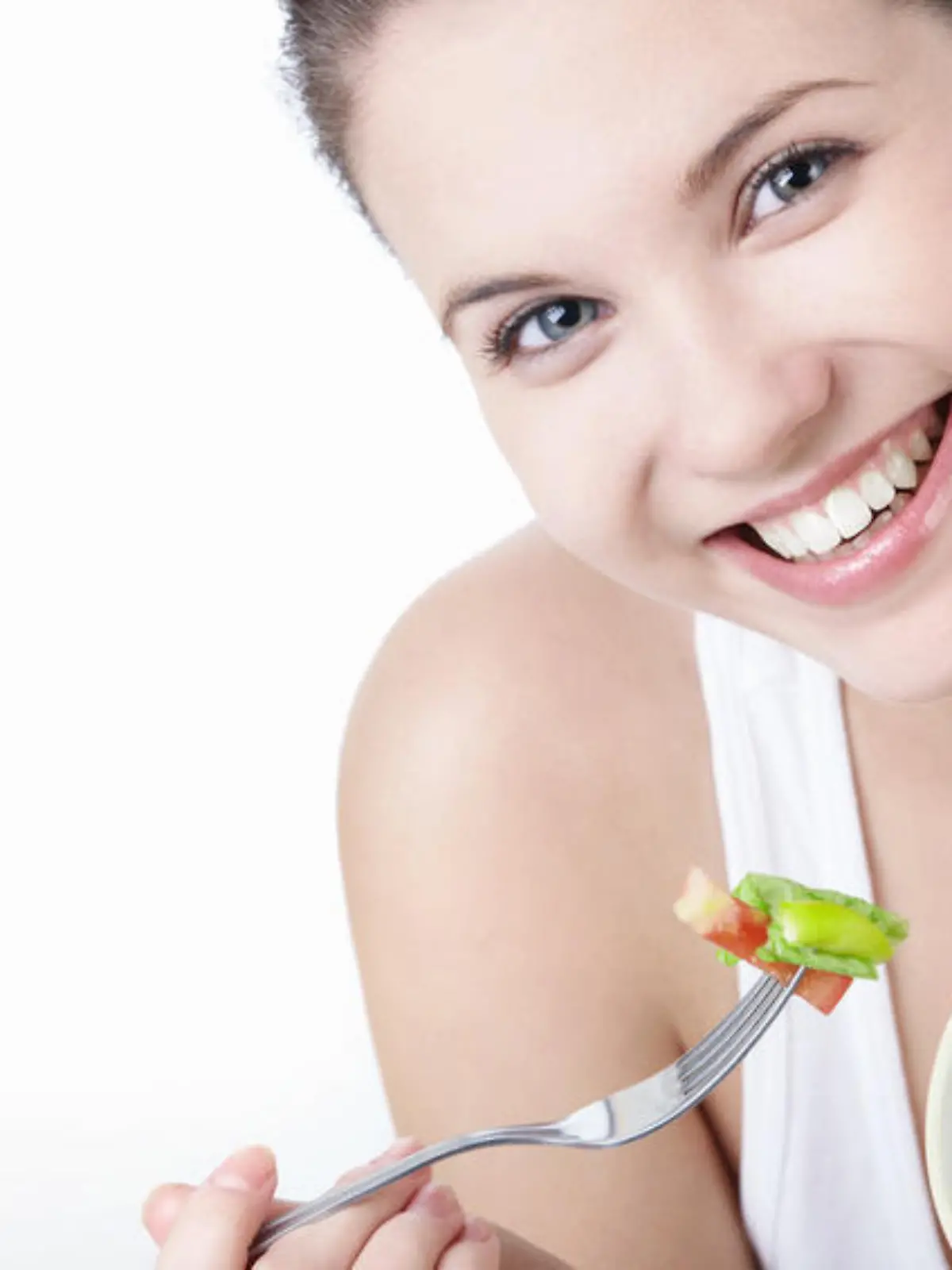 Smiling girl with a salad on a white background