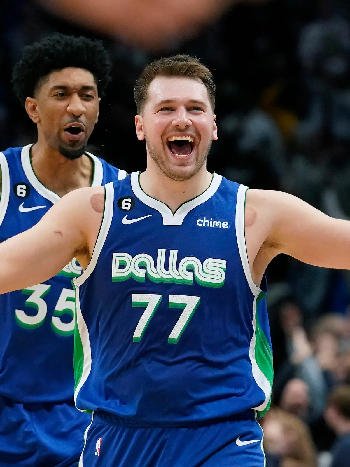 Dallas Mavericks guard Luka Doncic (77) celebrates scoring the game tying basket in front of teammate Christian Wood (35) during the fourth quarter of an NBA basketball game against the New York Knicks in Dallas, Tuesday, Dec. 27, 2022. The Mavericks won in overtime 126-121. (AP Photo/LM Otero)