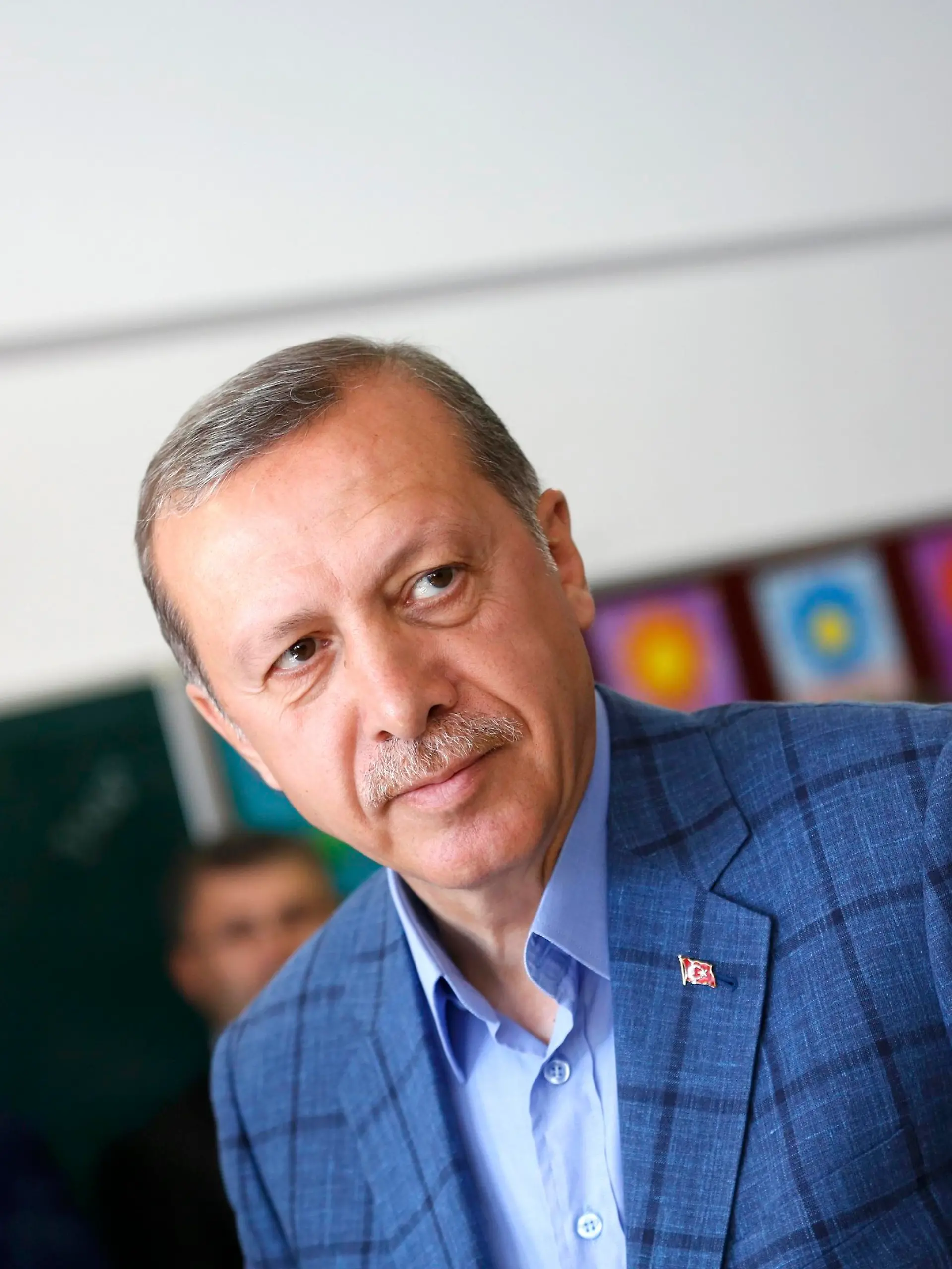 Turkey's Prime Minister Tayyip Erdogan prepares to leave a polling station during the municipal elections in Istanbul March 30, 2014. Erdogan looks set to win Sunday's municipal elections that have become a crisis referendum on his 10-year rule as he tries to ward off graft allegations and stem a stream of damaging security leaks. REUTERS/Murad Sezer (TURKEY  - Tags: POLITICS ELECTIONS)  