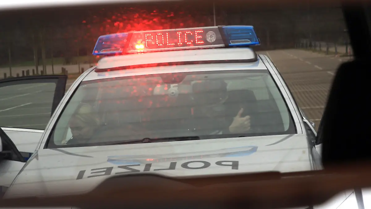 Ein Fahrzeug der Hamburger Polizei mit neuen Warn- und Unterstützungssignalen ist am 19.03.2014 bei einem Pressetermin in Hamburg im Rückspiegel eines Autos zu sehen. Mit den neuen Licht- und Tonsignalen, ein rotes Blitzlicht ("Flasher") und ein schriller Heulton ("Yelp"), will die Polizei Hamburg künftig Verkehrskontrollen durchsetzen. Foto: Christian Charisius/dpa +++(c) dpa - Bildfunk+++