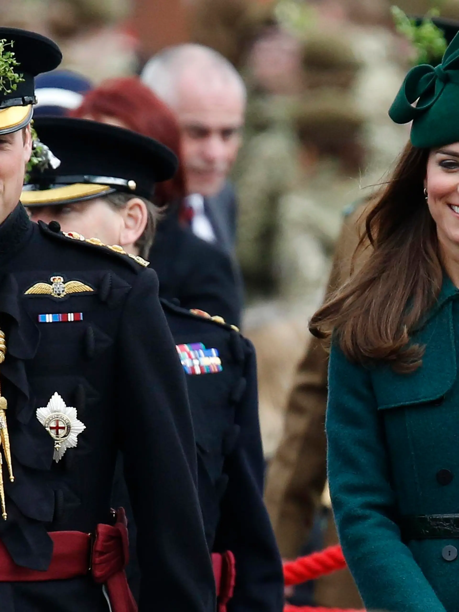 Britain's Catherine, Duchess of Cambridge and her husband Prince William wear sprigs of shamrock during a visit to the 1st Battalion Irish Guards for a St Patrick's Day Parade at Mons Barracks in Aldershot, southern England March 17, 2014. Prince William attended the Parade as Colonel of the Regiment, and the Duchess presented the traditional sprigs of shamrocks to the Officers and Guardsmen of the Regiment.   REUTERS/Luke MacGregor  (BRITAIN - Tags: ENTERTAINMENT MILITARY SOCIETY ROYALS)