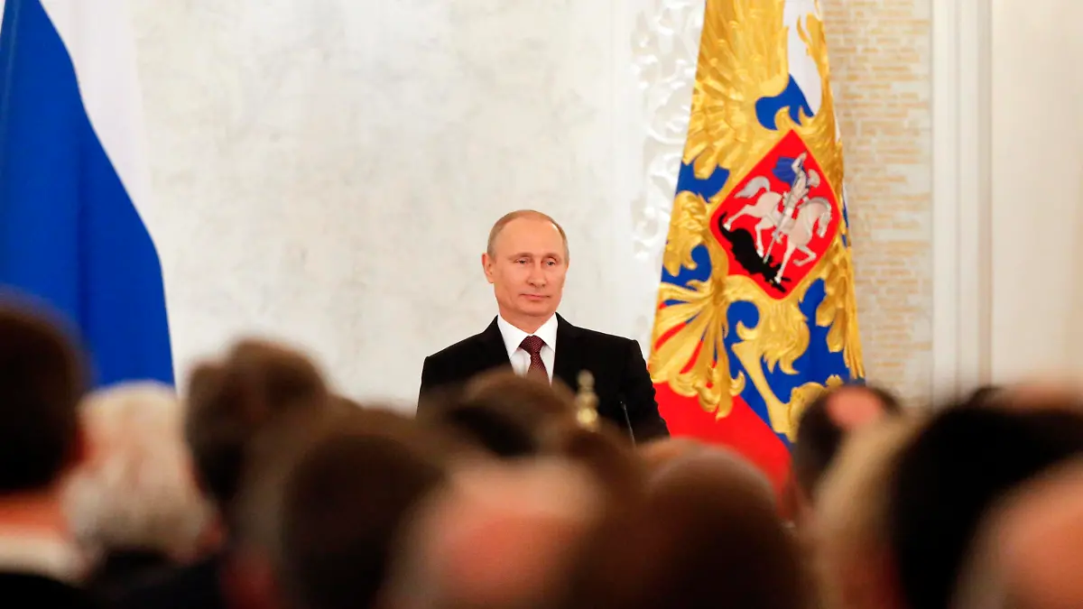 Russian President Vladimir Putin addresses the Federal Assembly, including State Duma deputies, members of the Federation Council, regional governors and civil society representatives, regarding the annexation of Ukraine's Crimea region, at the Kremlin in Moscow March 18, 2014. REUTERS/Maxim Shemetov (RUSSIA - Tags: POLITICS)