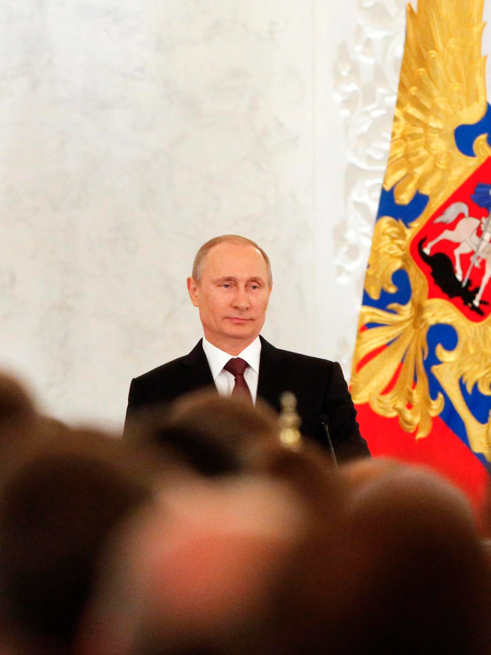 Russian President Vladimir Putin addresses the Federal Assembly, including State Duma deputies, members of the Federation Council, regional governors and civil society representatives, regarding the annexation of Ukraine's Crimea region, at the Kremlin in Moscow March 18, 2014. REUTERS/Maxim Shemetov (RUSSIA - Tags: POLITICS)