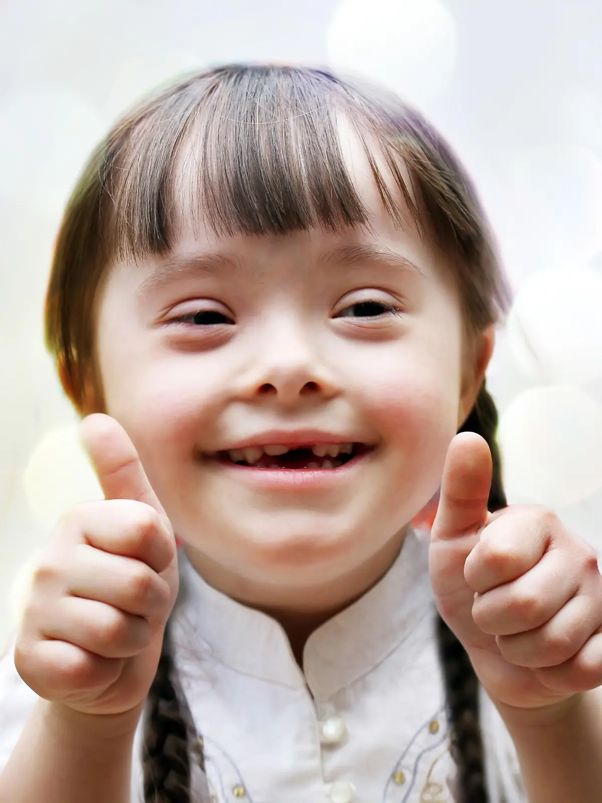 Portrait of beautiful happy girl giving thumbs up.