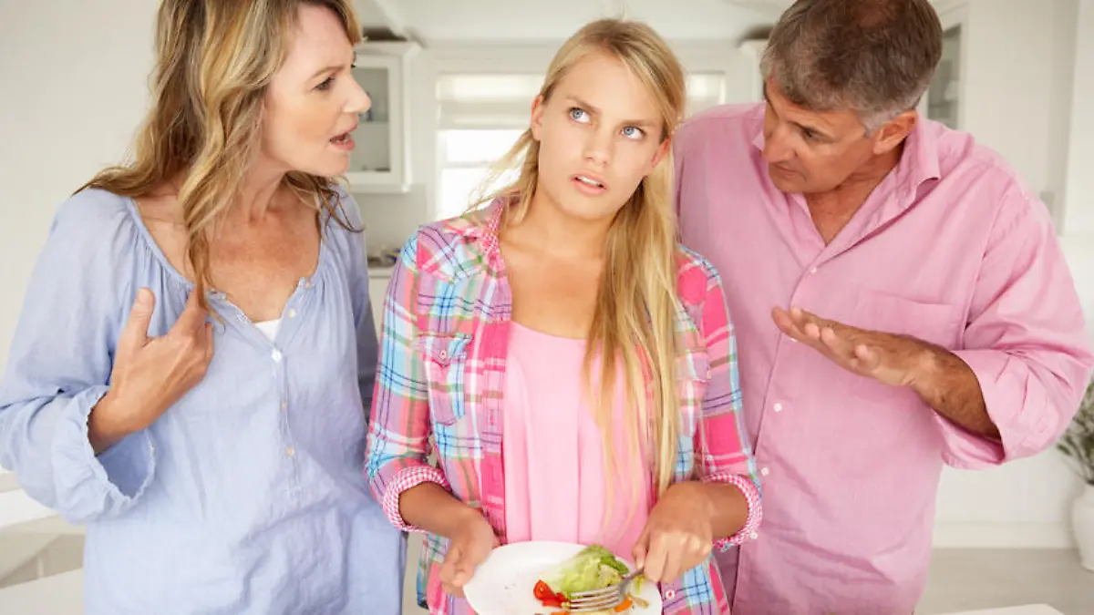 Parents making teenage daughter do chores at home