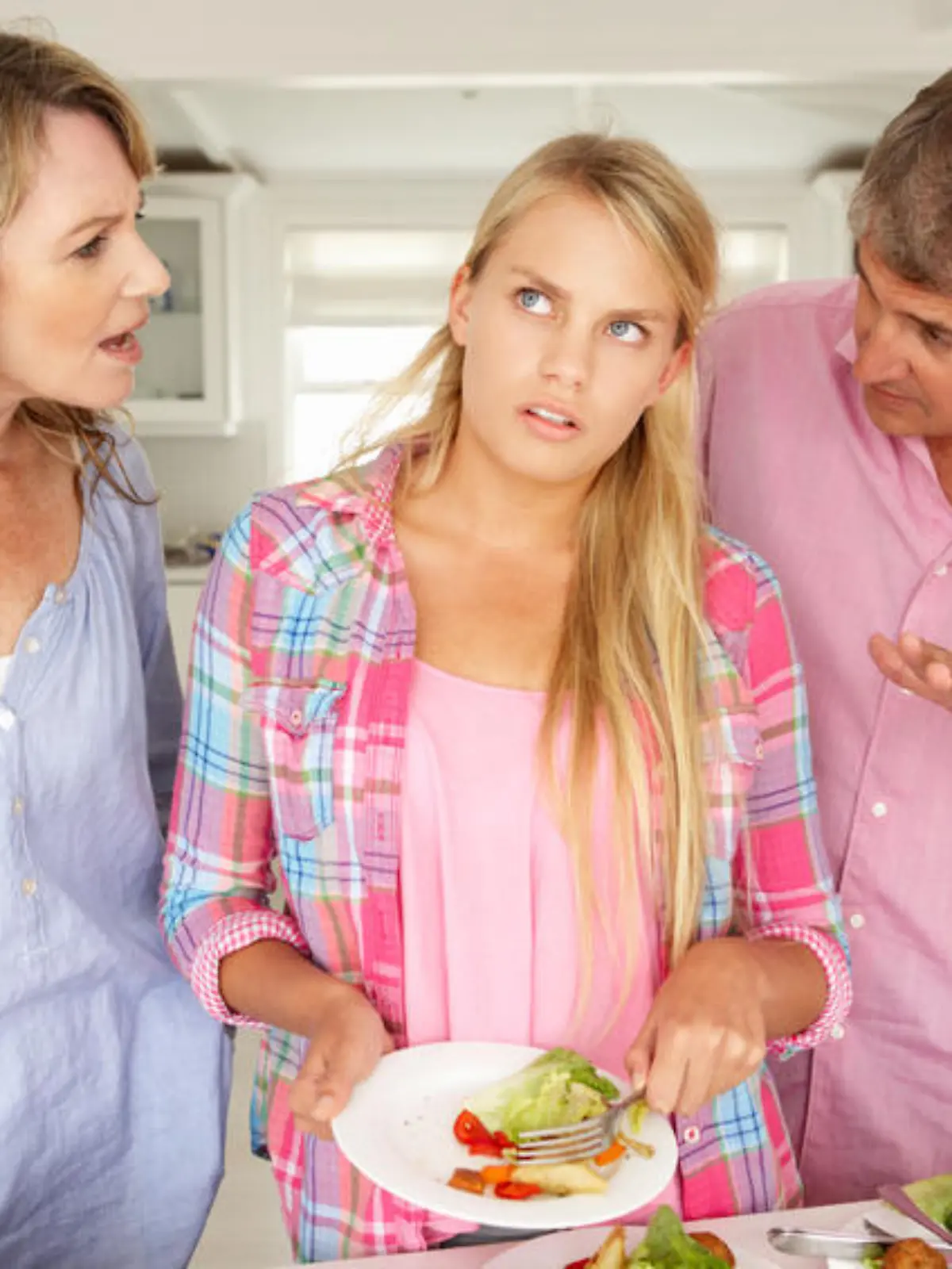 Parents making teenage daughter do chores at home