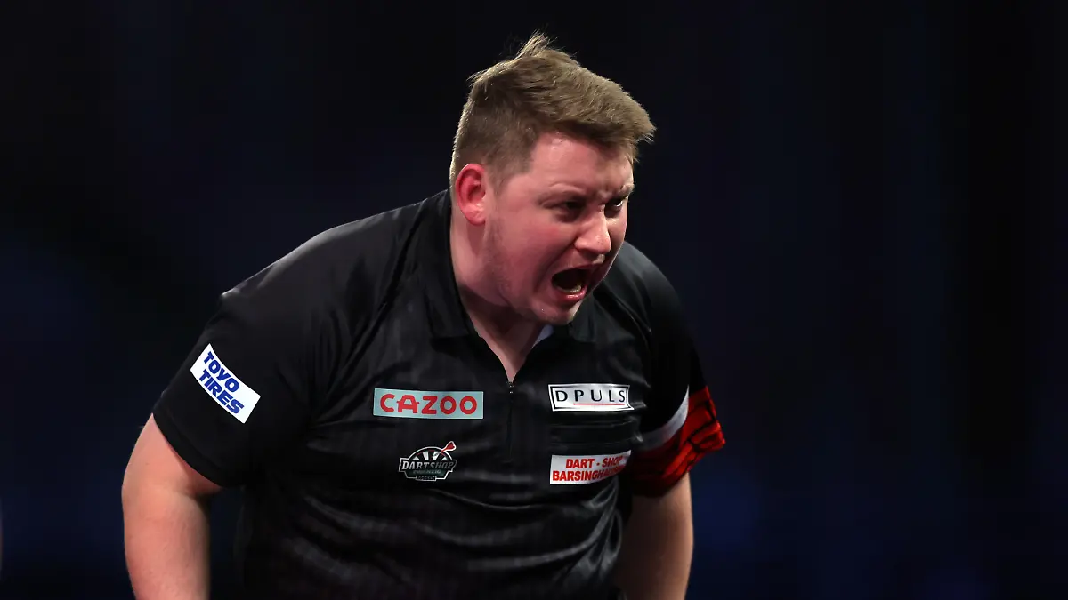 LONDON, ENGLAND - DECEMBER 28: Martin Schindler of Germany celebrates winning the third set during his Third Round match against Michael Smith of England during Day Nine of The Cazoo World Darts Championship at Alexandra Palace on December 28, 2022 in London, England. (Photo by Mike Owen/Getty Images)