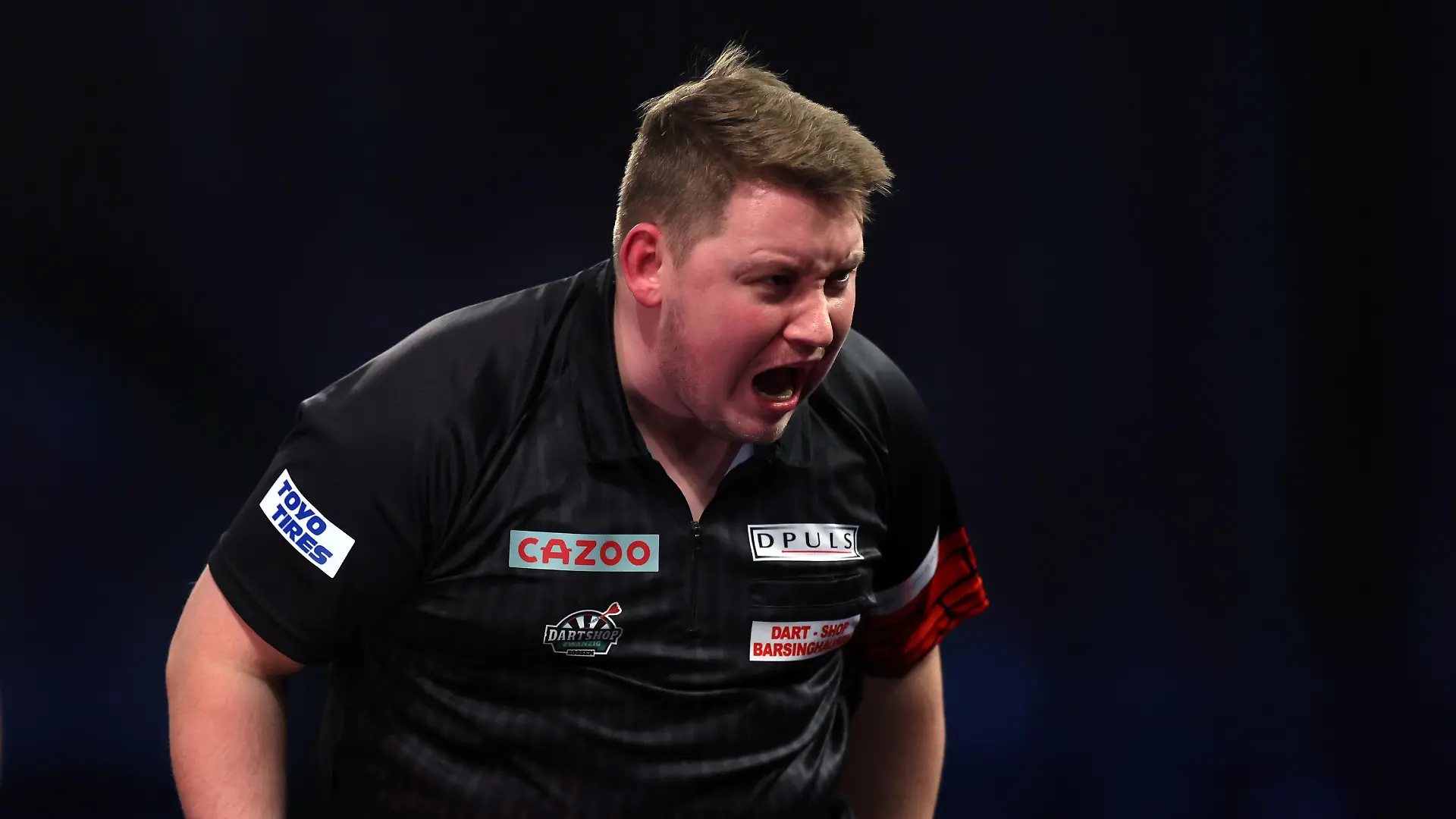 LONDON, ENGLAND - DECEMBER 28: Martin Schindler of Germany celebrates winning the third set during his Third Round match against Michael Smith of England during Day Nine of The Cazoo World Darts Championship at Alexandra Palace on December 28, 2022 in London, England. (Photo by Mike Owen/Getty Images)