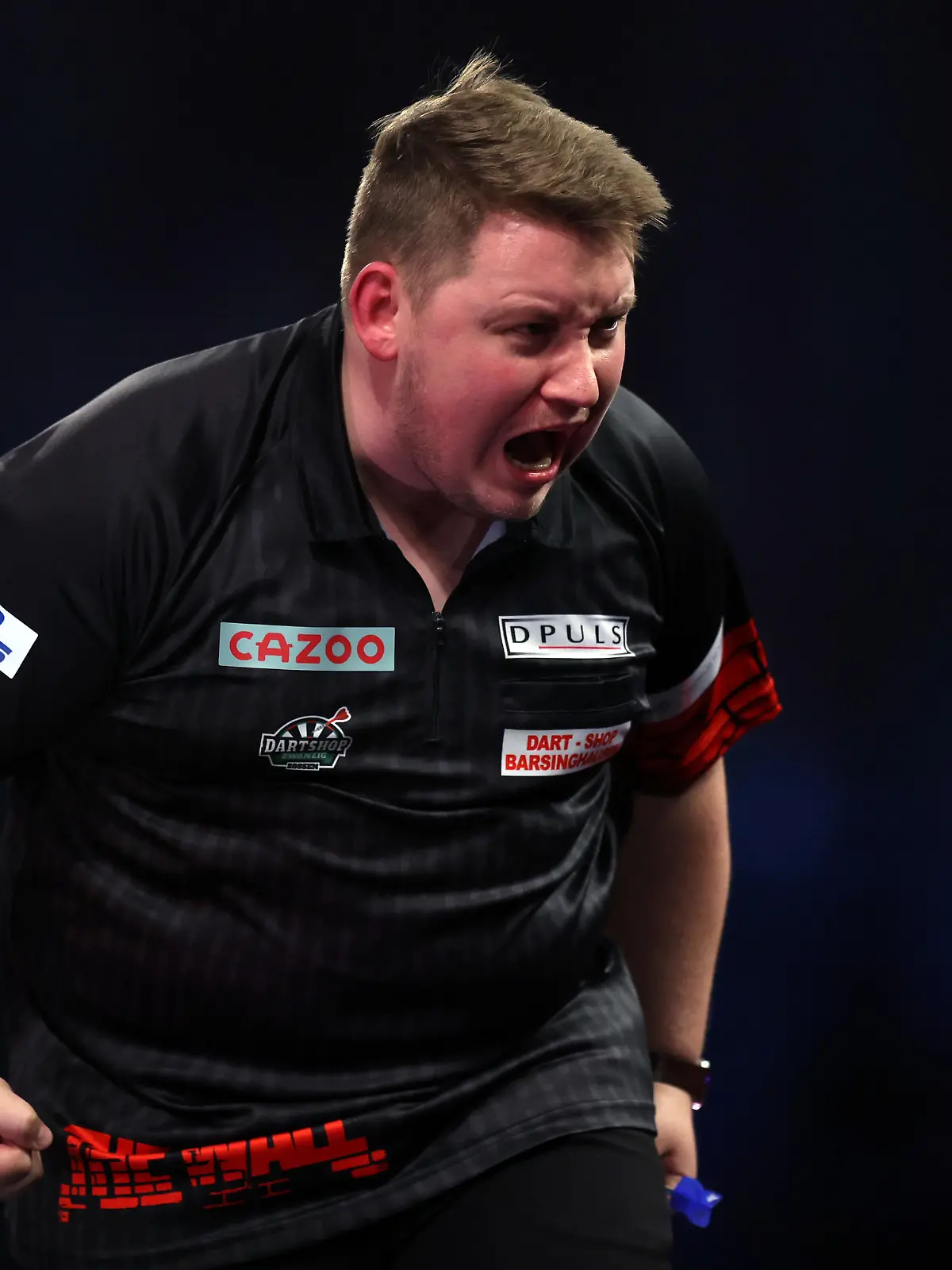 LONDON, ENGLAND - DECEMBER 28: Martin Schindler of Germany celebrates winning the third set during his Third Round match against Michael Smith of England during Day Nine of The Cazoo World Darts Championship at Alexandra Palace on December 28, 2022 in London, England. (Photo by Mike Owen/Getty Images)