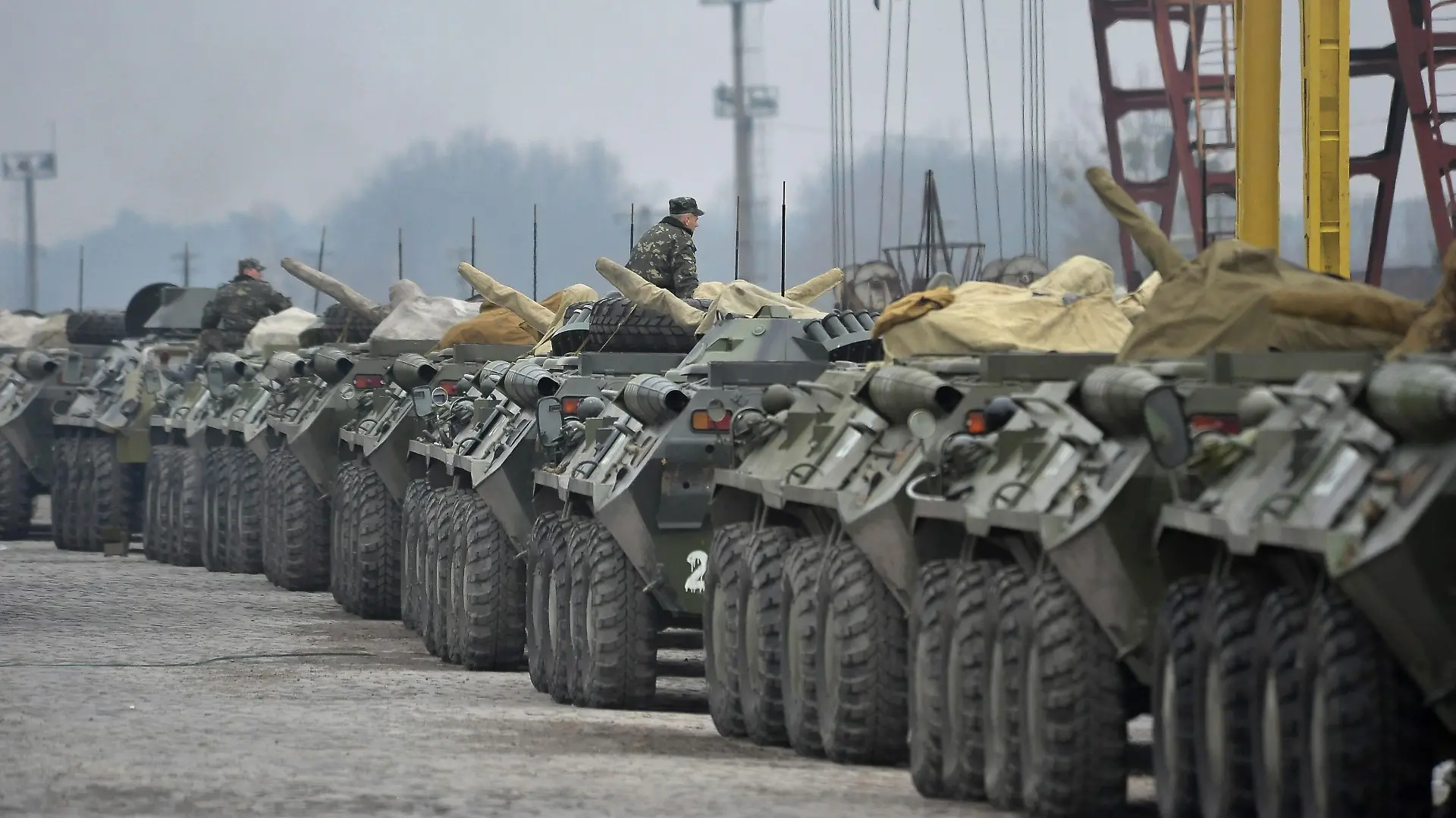 epa04115854 Ukrainian military vehicles line up to be loaded on flatcars at a railway station not far of Lviv, Ukraine, 08 March 2014. The USA and European Union have threatened sanctions against Moscow over the military standoff in the strategic Crimean peninsula, and are urging Russia to pull back its forces in the region and allow in international observers and human rights monitors. Crimea, which has a majority ethnic Russian population, is strategically important to Russia as the home port of its Black Sea Fleet. EPA/IVAN BOBERSKYY