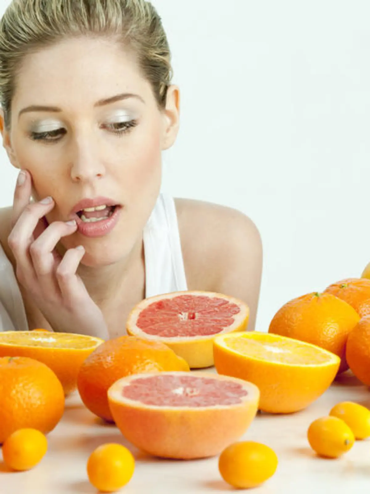 portrait of young woman with citrus fruit