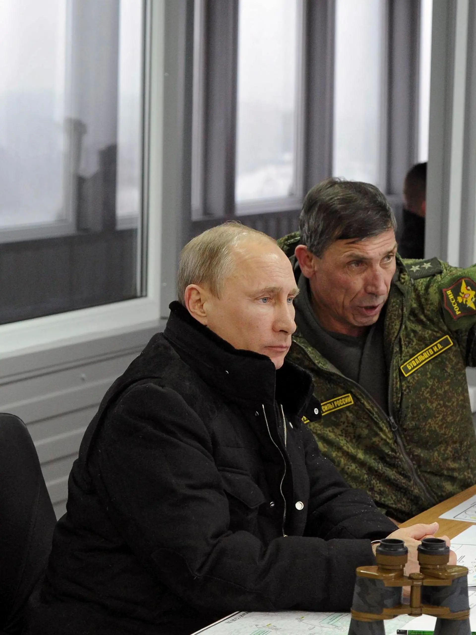 Russia's President Vladimir Putin (C), Defence Minister Sergei Shoigu (L) and head of the Russian army's main department of combat preparation Ivan Buvaltsev watch military exercises at the Kirillovsky firing ground in the Leningrad region, March 3, 2014. Putin on Monday watched Russian tanks and armoured vehicles trundle across the training ground in the north-west of the country, as Moscow flexed its muscle in a geo-political face-off with the West over Ukraine.    REUTERS/Mikhail Klimentyev/RIA Novosti/Kremlin (RUSSIA - Tags: POLITICS MILITARY TPX IMAGES OF THE DAY) ATTENTION EDITORS - THIS IMAGE HAS BEEN SUPPLIED BY A THIRD PARTY. IT IS DISTRIBUTED, EXACTLY AS RECEIVED BY REUTERS, AS A SERVICE TO CLIENTS
