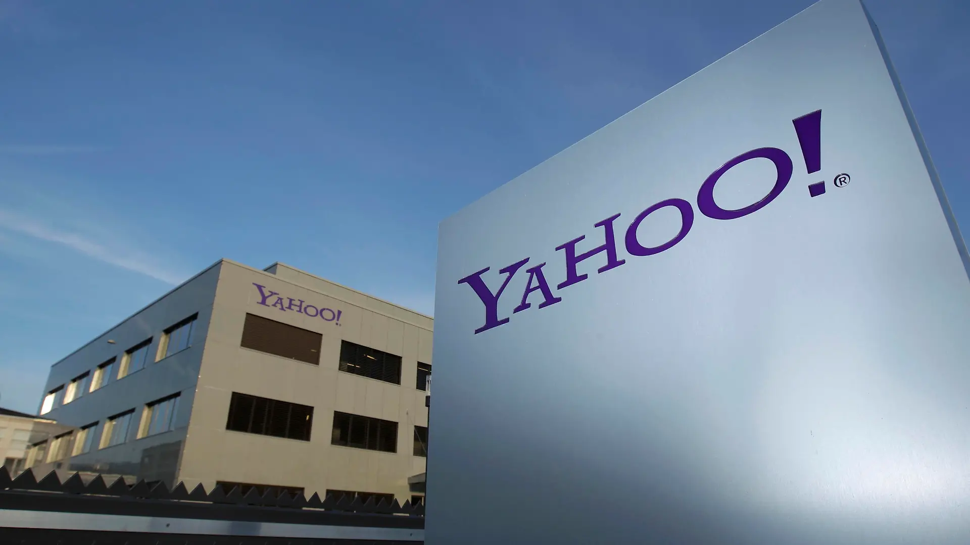 A Yahoo logo is pictured in front of a building in Rolle, 30 km (19 miles) east of Geneva, in this file picture taken December 12, 2012. Yahoo! Inc is shifting its main European tax base to Ireland from Switzerland, a Reuters examination of company statements and accounts shows, as pressure mounts on the Alpine nation to abolish some corporate tax incentives. Picture taken December 12, 2012. REUTERS/Denis Balibouse (SWITZERLAND - Tags: BUSINESS POLITICS LOGO)