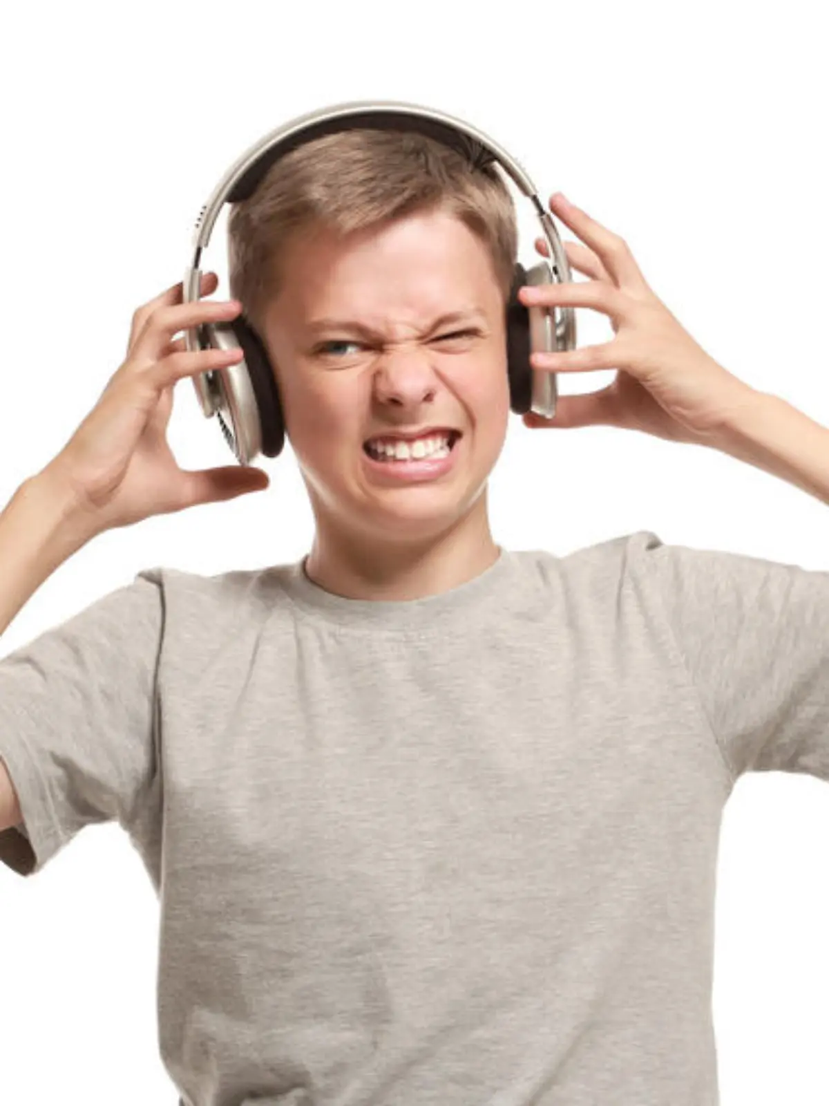 Angry teenage boy takes off headphones. Isolated on white background