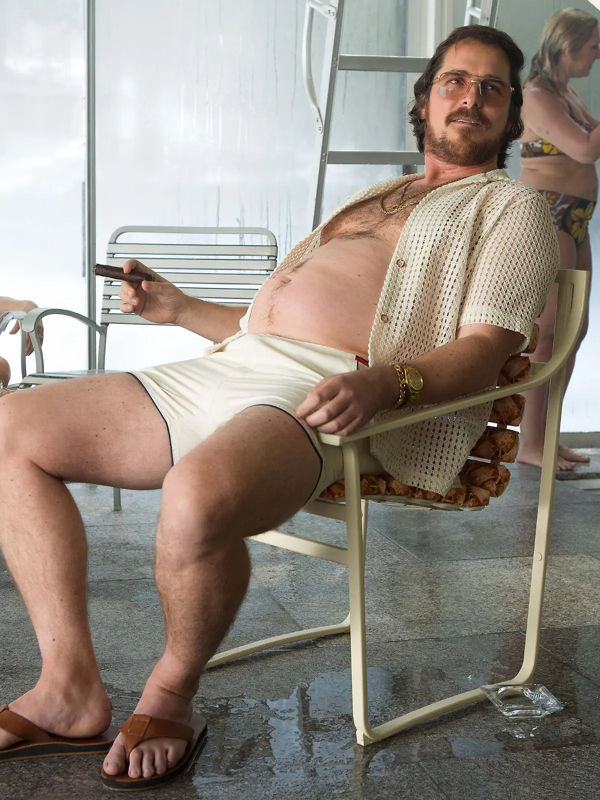 Irving Rosenfeld (Christian Bale) at Pool Party in Columbia Pictures' AMERICAN HUSTLE.