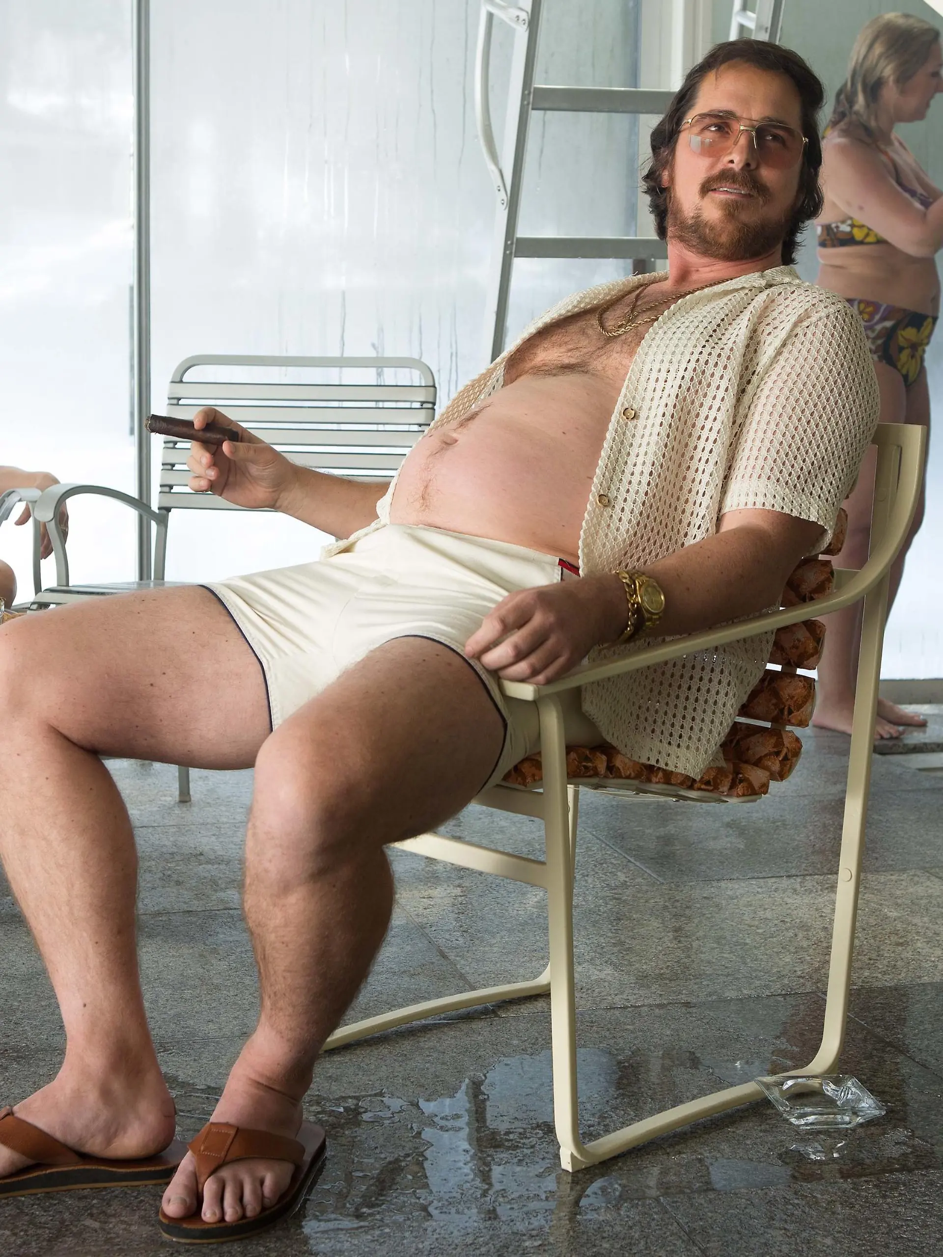 Irving Rosenfeld (Christian Bale) at Pool Party in Columbia Pictures' AMERICAN HUSTLE.