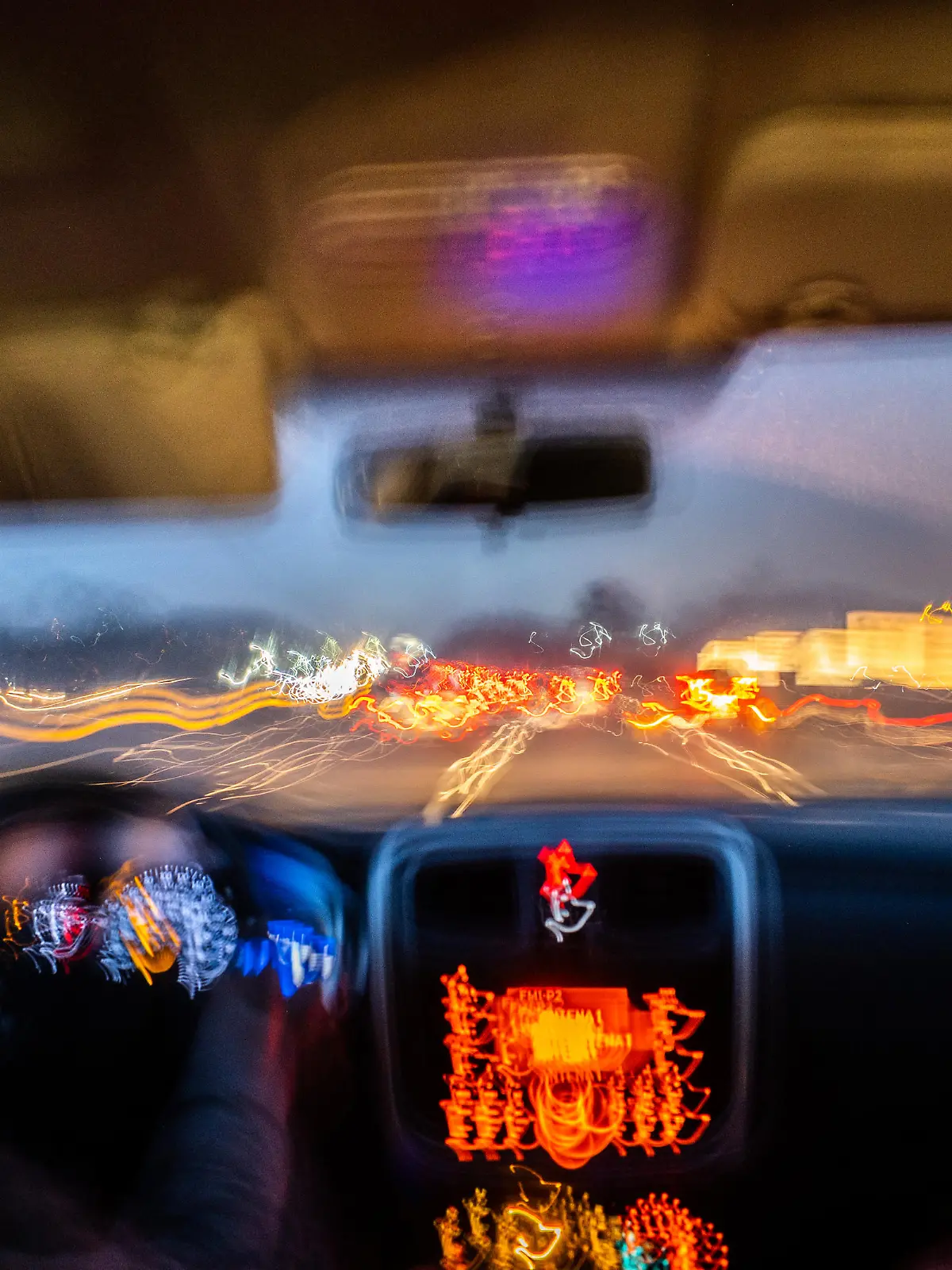 Blurred photo from inside a car at night