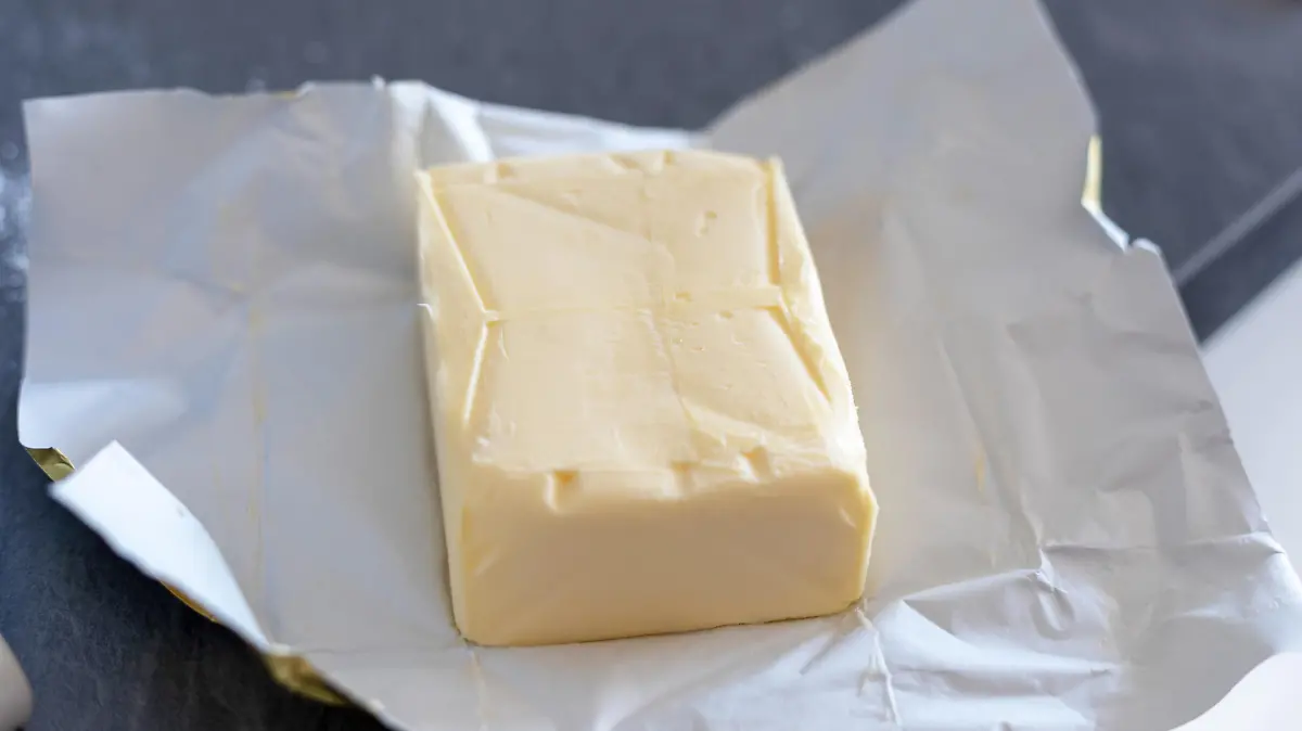 Butter stick on grey board. Baking or cooking concept
