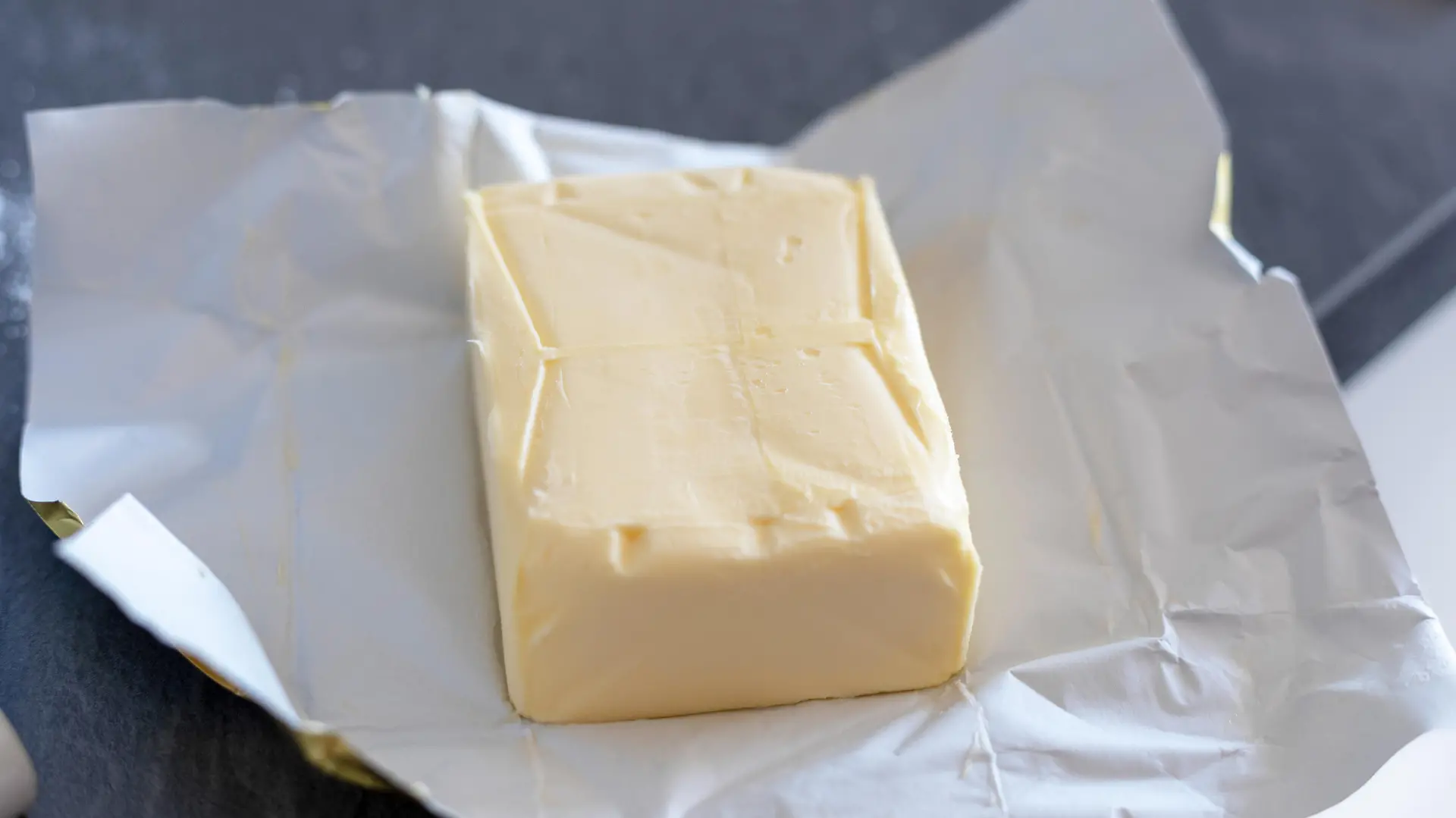 Butter stick on grey board. Baking or cooking concept