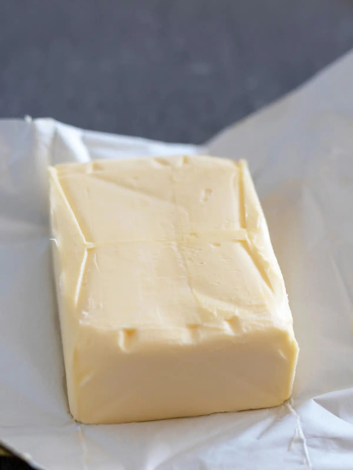 Butter stick on grey board. Baking or cooking concept