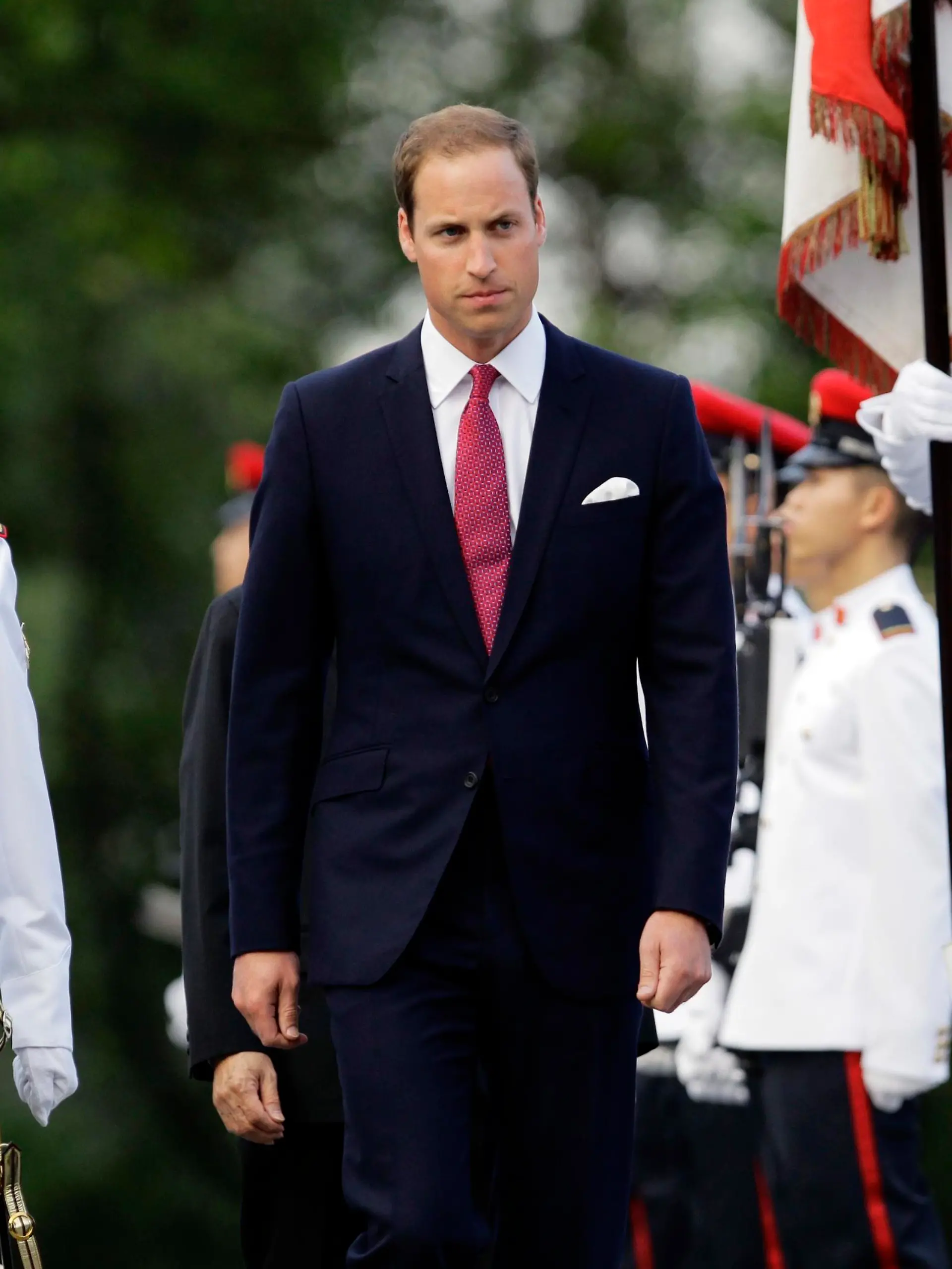 Britain's Prince William (C) inspects an honour guard during a welcoming ceremony at the Istana presidential palace in Singapore September 11, 2012. Prince William and Catherine, Duchess of Cambridge, are in the city-state for a three-day visit as part of a tour to mark Queen Elizabeth II's Diamond Jubilee. REUTERS/Tim Chong (SINGAPORE - Tags: ROYALS ENTERTAINMENT POLITICS)