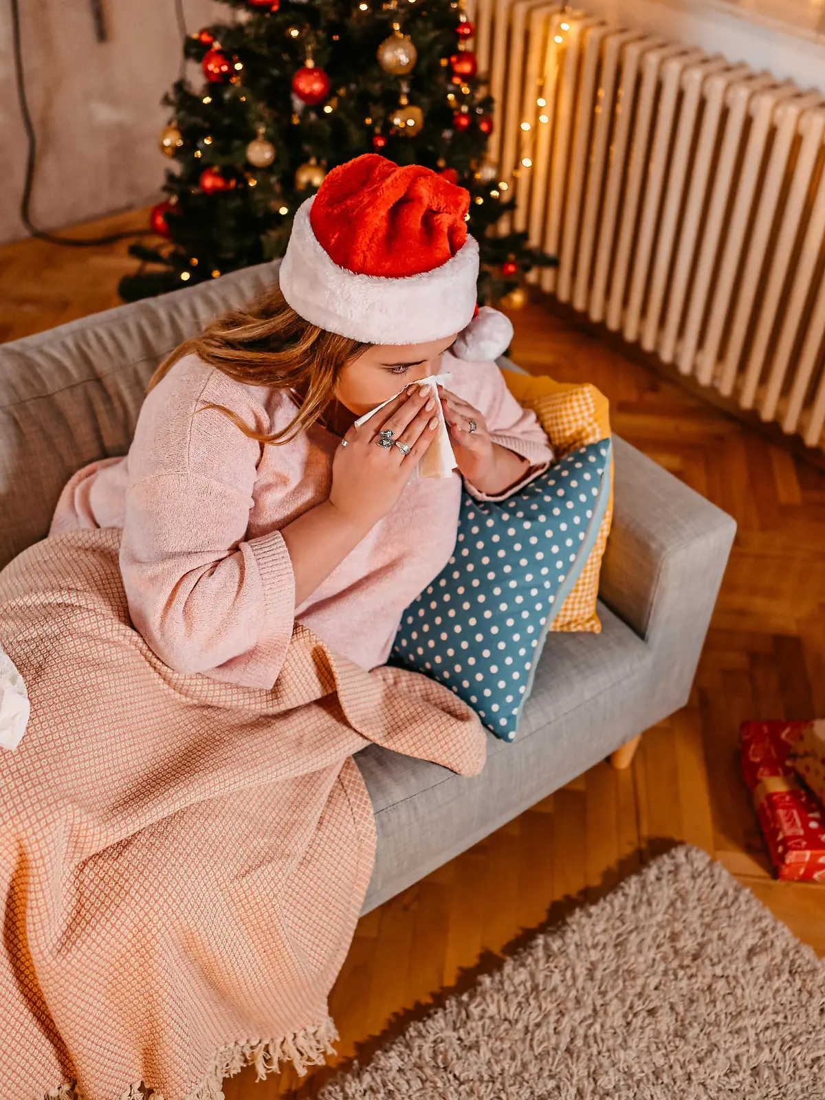Beautiful young plus size woman being sick at home for Christmas.