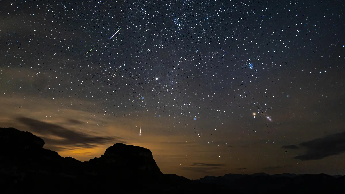 Perseid meteor shower. Stacked image of several meteors entering the atmosphere during the perseids. astrophotography with milky way and mountains