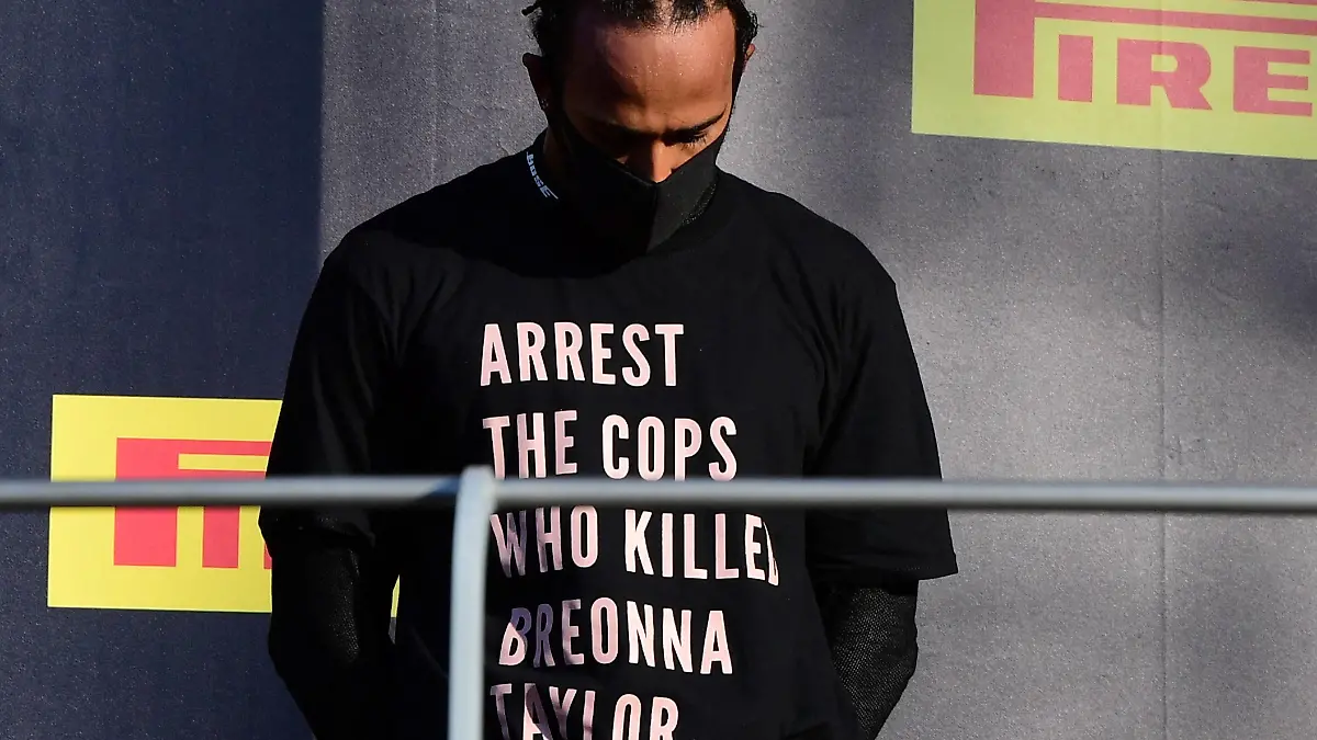 FILE PHOTO: Formula One F1 - Tuscan Grand Prix - Mugello, Scarperia e San Piero, Italy - September 13, 2020 Mercedes' Lewis Hamilton wears a shirt in reference to Breonna Taylor on the podium as he celebrates after winning the race Pool via REUTERS/Jennifer Lorenzini/File Photo