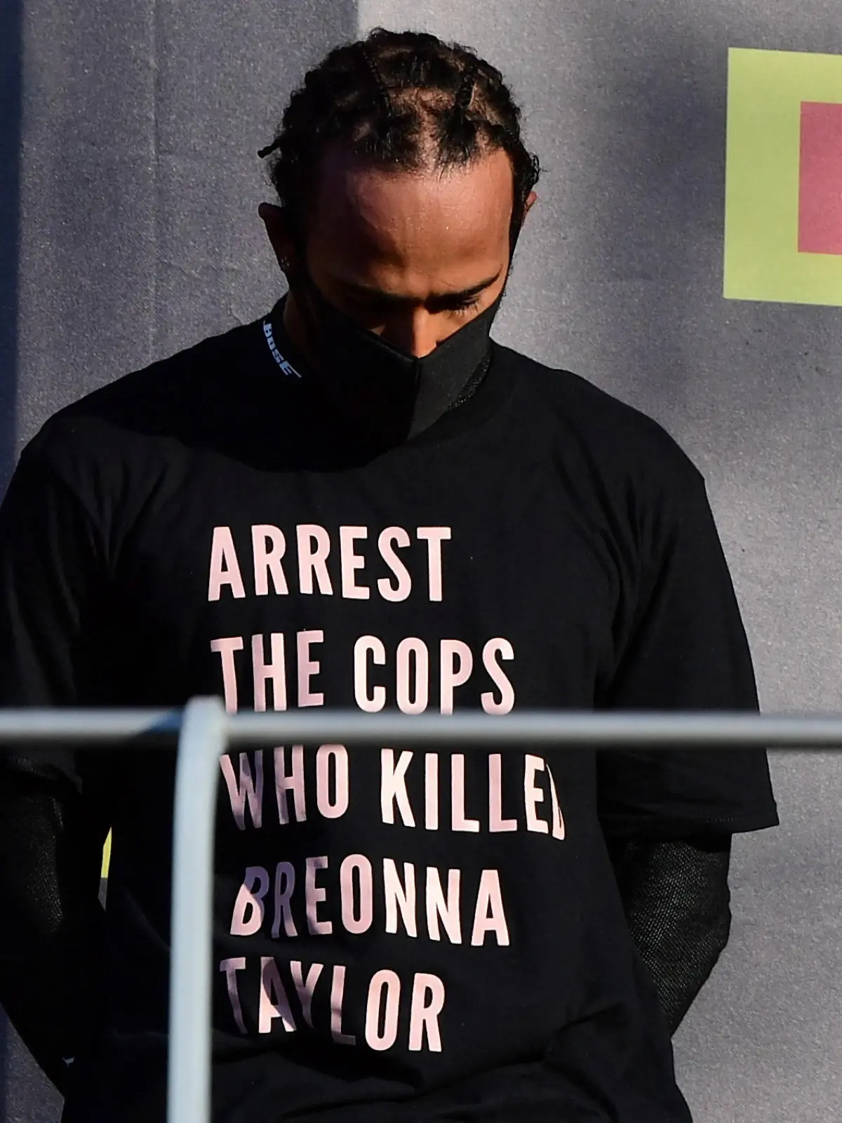 FILE PHOTO: Formula One F1 - Tuscan Grand Prix - Mugello, Scarperia e San Piero, Italy - September 13, 2020 Mercedes' Lewis Hamilton wears a shirt in reference to Breonna Taylor on the podium as he celebrates after winning the race Pool via REUTERS/Jennifer Lorenzini/File Photo