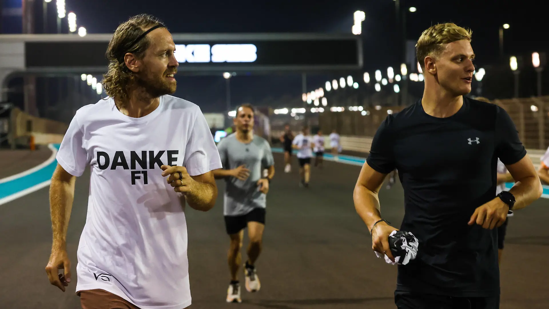 Formula 1 2022: Abu Dhabi GP YAS MARINA CIRCUIT, UNITED ARAB EMIRATES - NOVEMBER 19: Sebastian Vettel, Aston Martin, is joined on a run around the circuit by Mick Schumacher, Haas F1 Team, and well wishers as part of his farewell at his final Grand Prix during the Abu Dhabi GP at Yas Marina Circuit on Saturday November 19, 2022 in Abu Dhabi, United Arab Emirates. Photo by Glenn Dunbar / LAT Images Images PUBLICATIONxINxGERxSUIxAUTxHUNxONLY GP2222_171944177A9587