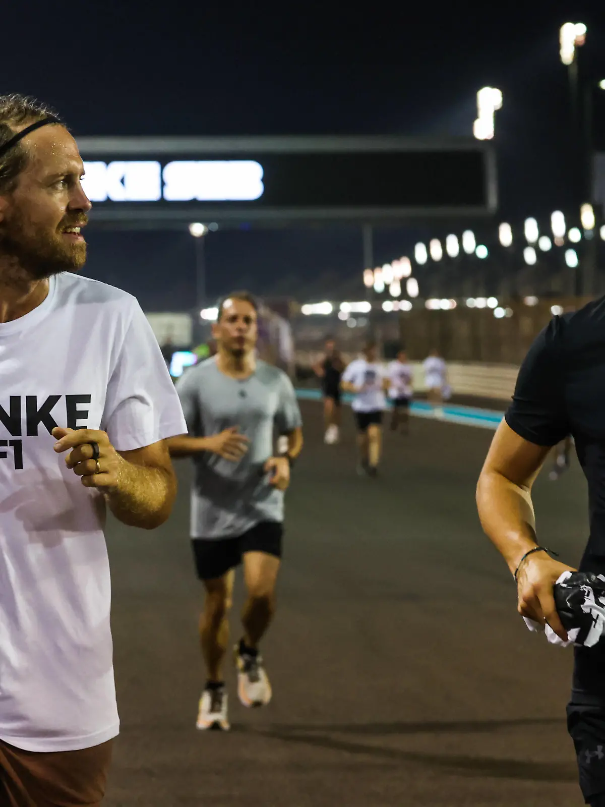  Formula 1 2022: Abu Dhabi GP YAS MARINA CIRCUIT, UNITED ARAB EMIRATES - NOVEMBER 19: Sebastian Vettel, Aston Martin, is joined on a run around the circuit by Mick Schumacher, Haas F1 Team, and well wishers as part of his farewell at his final Grand Prix during the Abu Dhabi GP at Yas Marina Circuit on Saturday November 19, 2022 in Abu Dhabi, United Arab Emirates. Photo by Glenn Dunbar / LAT Images Images PUBLICATIONxINxGERxSUIxAUTxHUNxONLY GP2222_171944177A9587