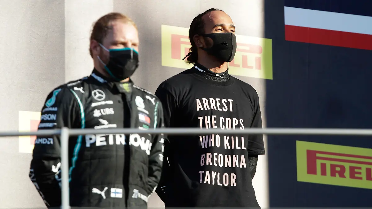 SCARPERIA, ITALY - SEPTEMBER 13: Race winner Lewis Hamilton of Great Britain and Mercedes GP wears a shirt in tribute to the late Breonna Taylor as he stands on the podium during the F1 Grand Prix of Tuscany at Mugello Circuit on September 13, 2020 in Scarperia, Italy. (Photo by Luca Bruno - Pool/Getty Images)