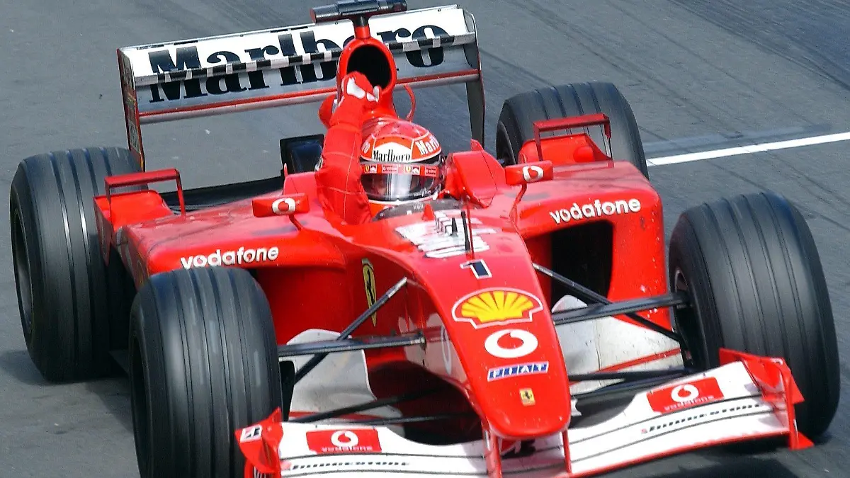 Der deutsche Formel-1-Pilot Michael Schumacher (Ferrari) reckt am 03.03.2002 bei der Zieldurchfahrt auf der Rennstrecke im Albert-Park von Melbourne beim Großen Preis von Australien die Faust aus dem Cockpit. Der viermalige Weltmeister aus Kerpen gewinnt das dramatische Auftaktrennen zur Formel-1-Weltmeisterschaft 2002 und feiert damit einen Saisonstart nach Maß.