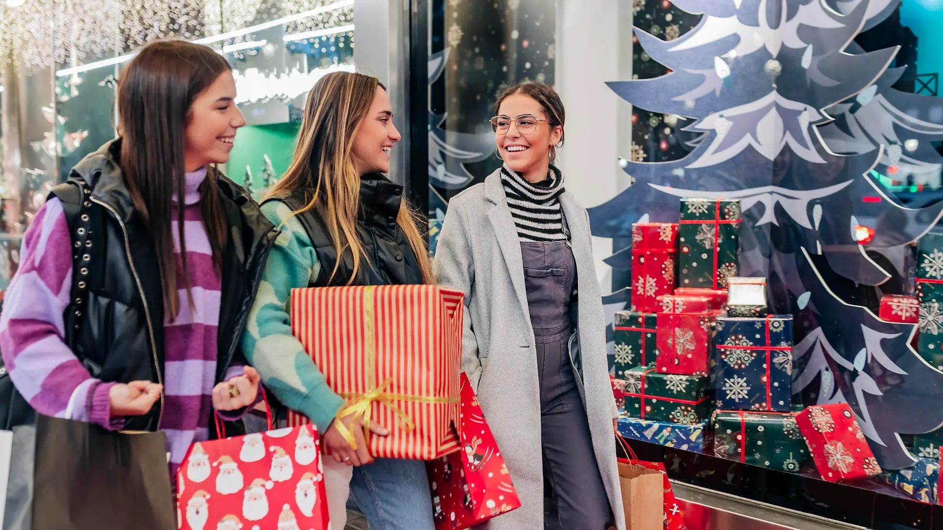 Smiling young friends walking with shopping bags by store model released, JRVF02707