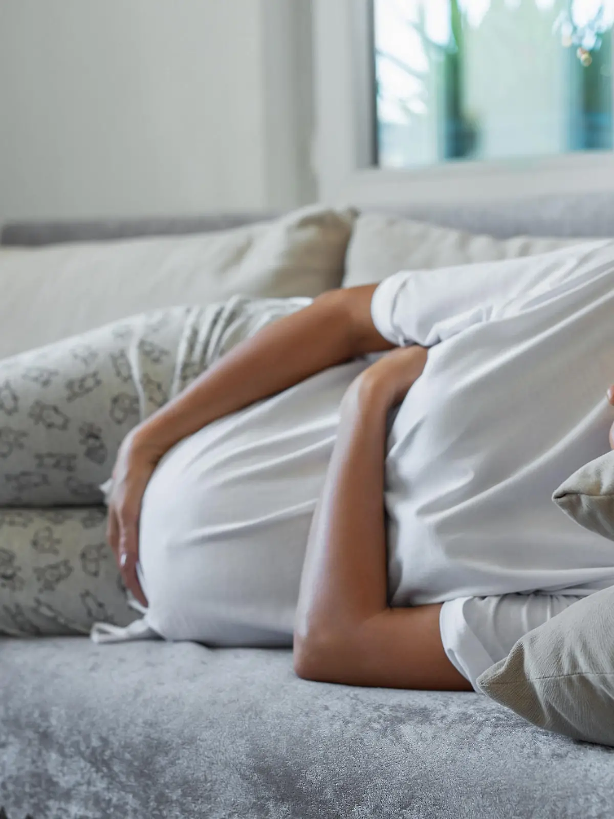 Pregnant woman lying on sofa