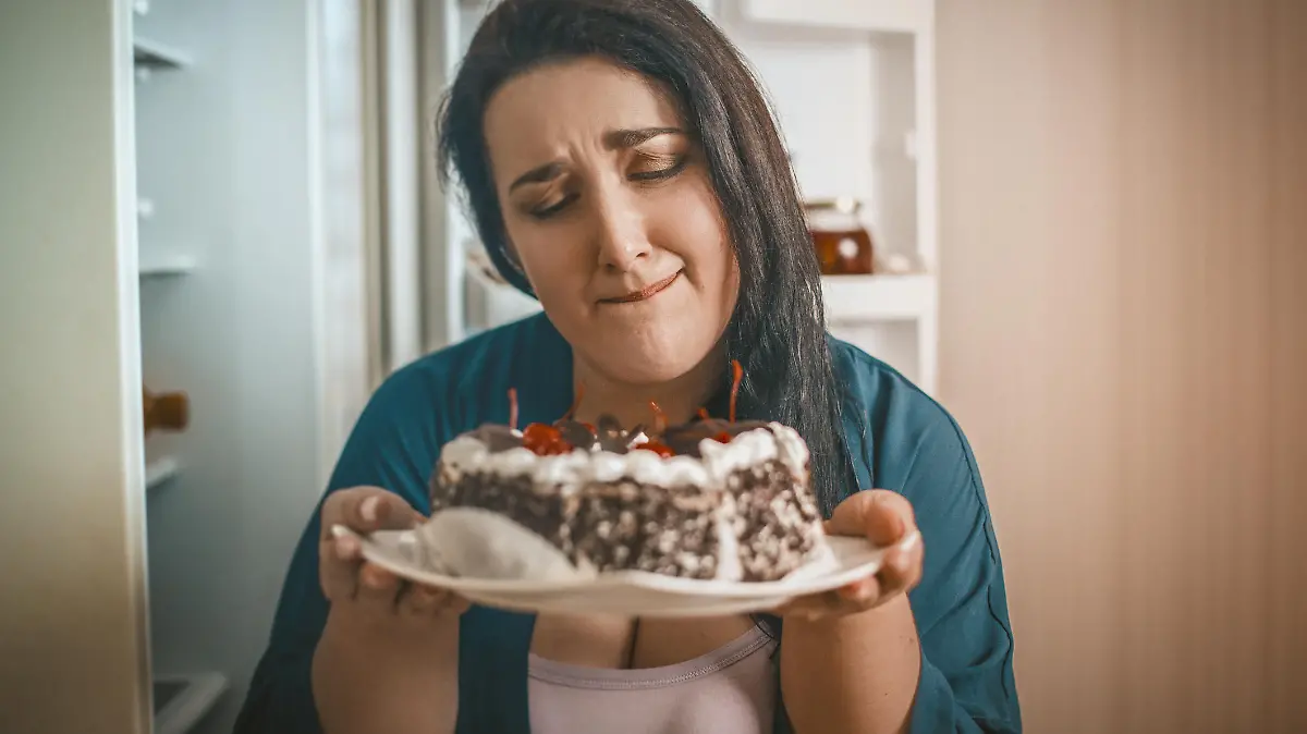 Plus Size Woman Holding A Plate With Chocolate Cherry Cake Passionately Wanting To Eat It, Hungry Woman Wants To Eat Dessert Standing In Front Of An Open Refrigerator