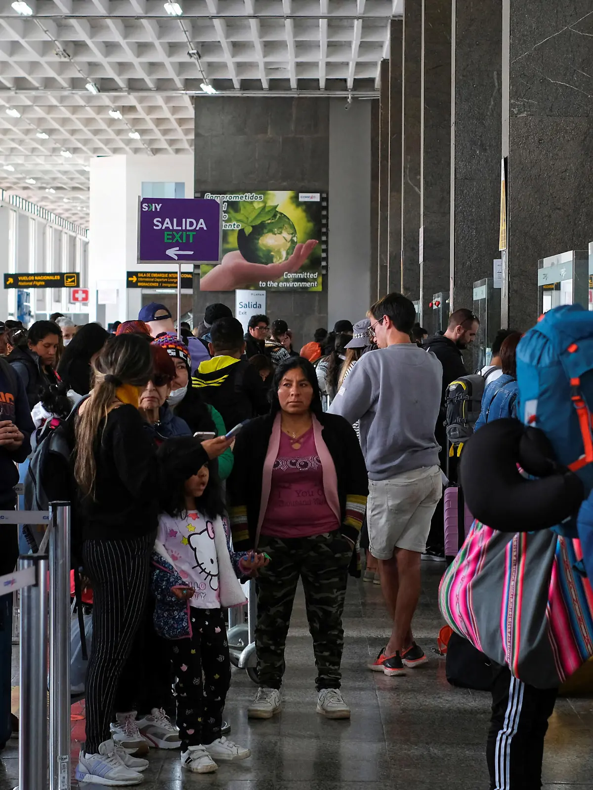 Travelers wait in line in front of airline counters for news about flights at the airport, after it was closed due to protests sparked by the ousting of former President Pedro Castillo, in Cuzco, Peru December 16, 2022. REUTERS/Paul Gambin NO RESALES. NO ARCHIVES.