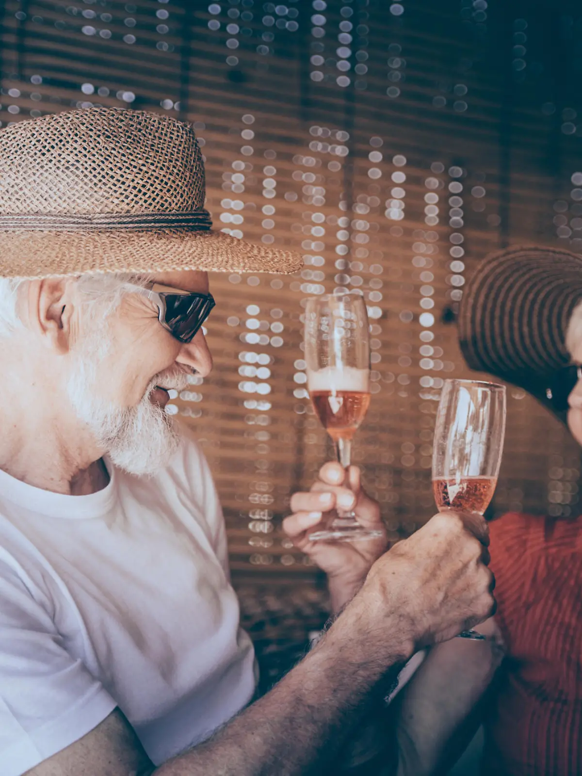 Senior couple enjoying summer vacations with champagne. Horizontal color image.