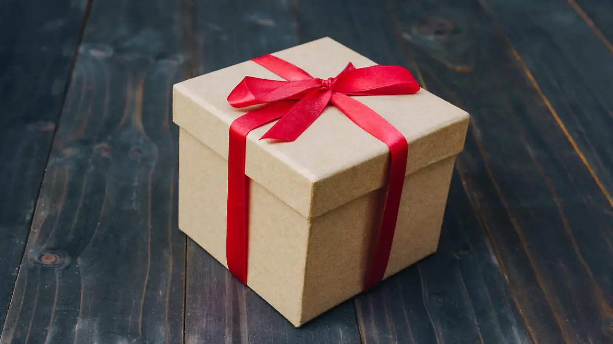 brown gift box on wooden table background with copy space.