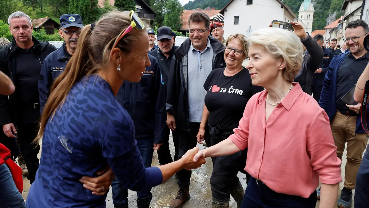 European Commission President Ursula von der Leyen shakes hands with Slovenian alpine ski racer Tina Maze, as she visits affected areas after northern and western parts of the country were hit by torrential rains causing floods, cutting power and disrupting traffic, in Crna na Koroskem, Slovenia August 9, 2023. REUTERS/Borut Zivulovic