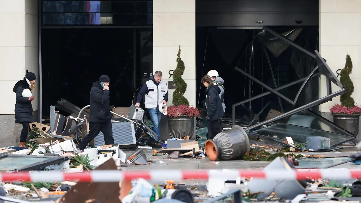 Emergency services work on a street outside a hotel after a burst and leak of the AquaDom aquarium in central Berlin near Alexanderplatz, with water poured out onto the street, in Berlin, Germany, December 16, 2022. REUTERS/Michele Tantussi