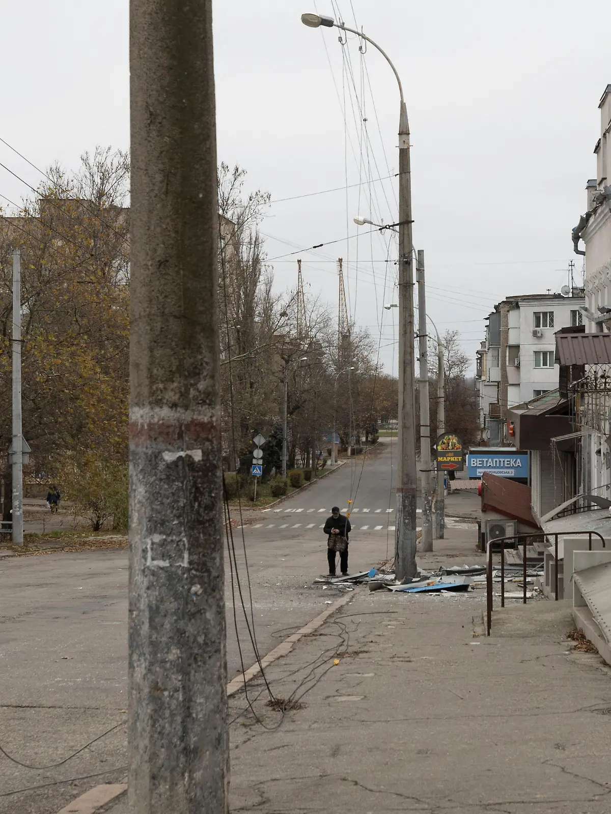 A man walks past a residential building where elderly woman was killed during a shelling of Russian troops, amid Russia's attack on Ukraine continues, in Kherson, Ukraine December 1, 2022. REUTERS/Anna Voitenko