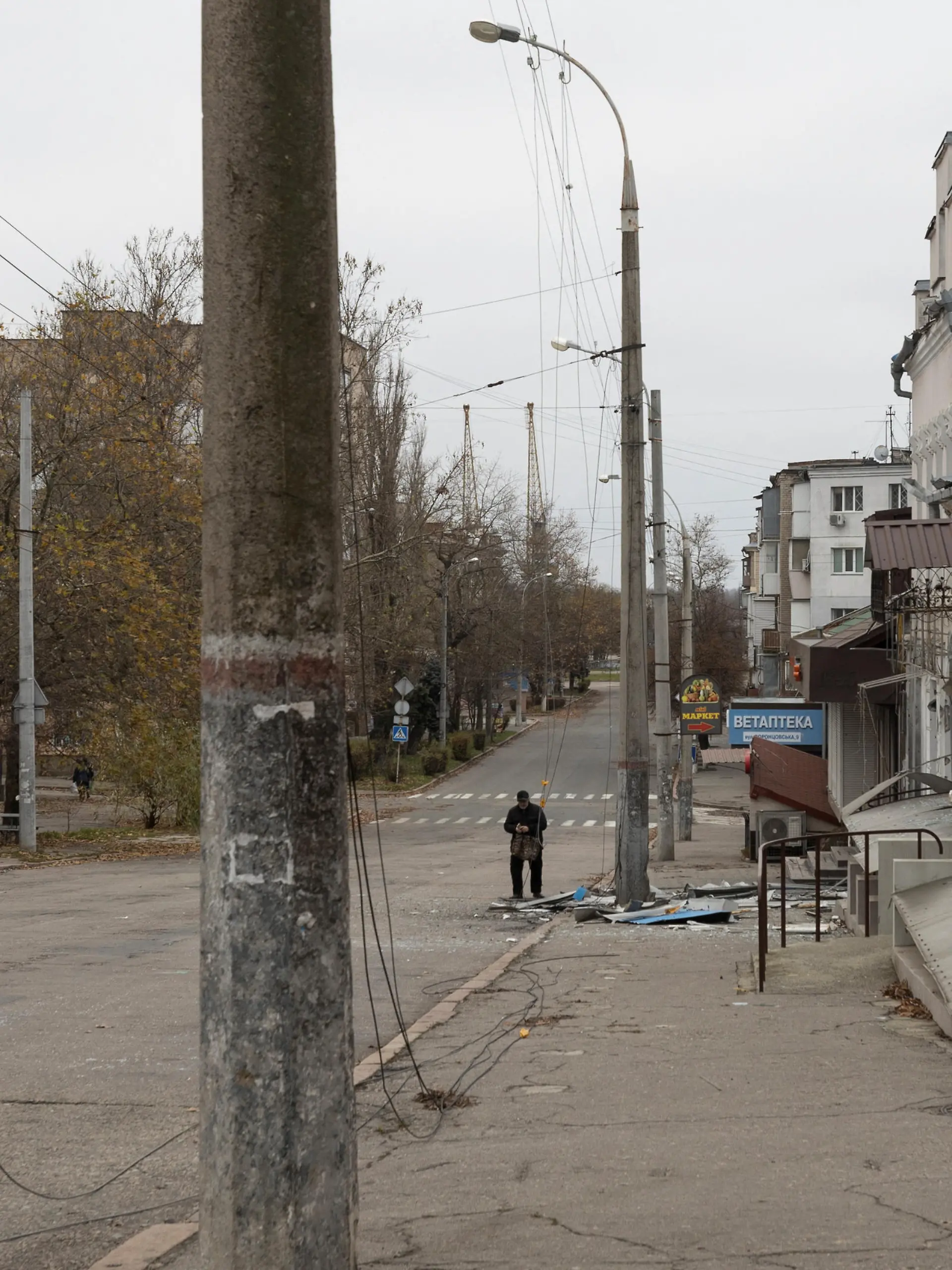 A man walks past a residential building where elderly woman was killed during a shelling of Russian troops, amid Russia's attack on Ukraine continues, in Kherson, Ukraine December 1, 2022. REUTERS/Anna Voitenko