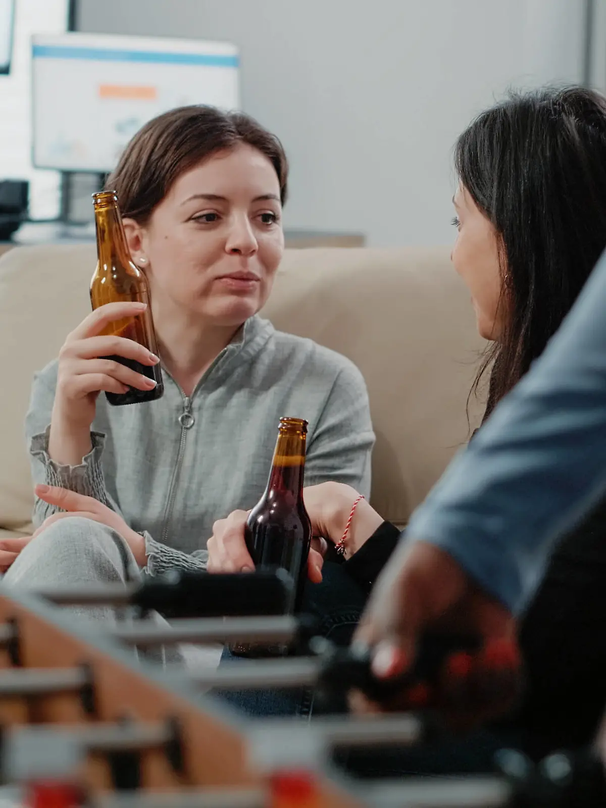 IMAGO Creative: Business - Work-Life Balance  Close up of women with bottles of beer and snacks talking Close up of women with bottles of beer and snacks talking at office after work. Colleagues enjoying free time with alcoholic beverage to do fun activity with entertainment after hours Copyright: xx 43945936