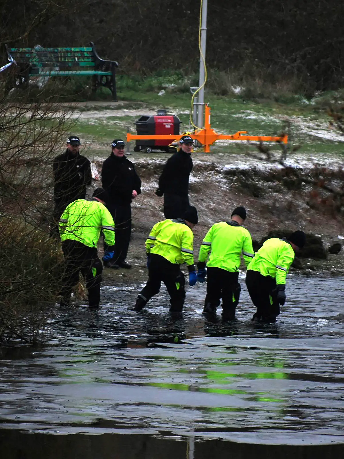 Police search teams at the scene after children fell through ice,in Babbs Mill Park in Kingshurst, Solihull, England, Monday, Dec. 12, 2022. Three young boys who fell through ice covering a lake in central England have died and a fourth remains hospitalized as weather forecasters issued severe weather warnings for large parts of the United Kingdom. Rescuers pulled the boys, aged 8, 10 and 11, from the icy waters Sunday afternoon and rushed them to the hospital in the West Midlands, about 100 miles (160 kilometers) north of London. But they could not be revived after suffering cardiac arrest. (Matthew Cooper/PA via AP)